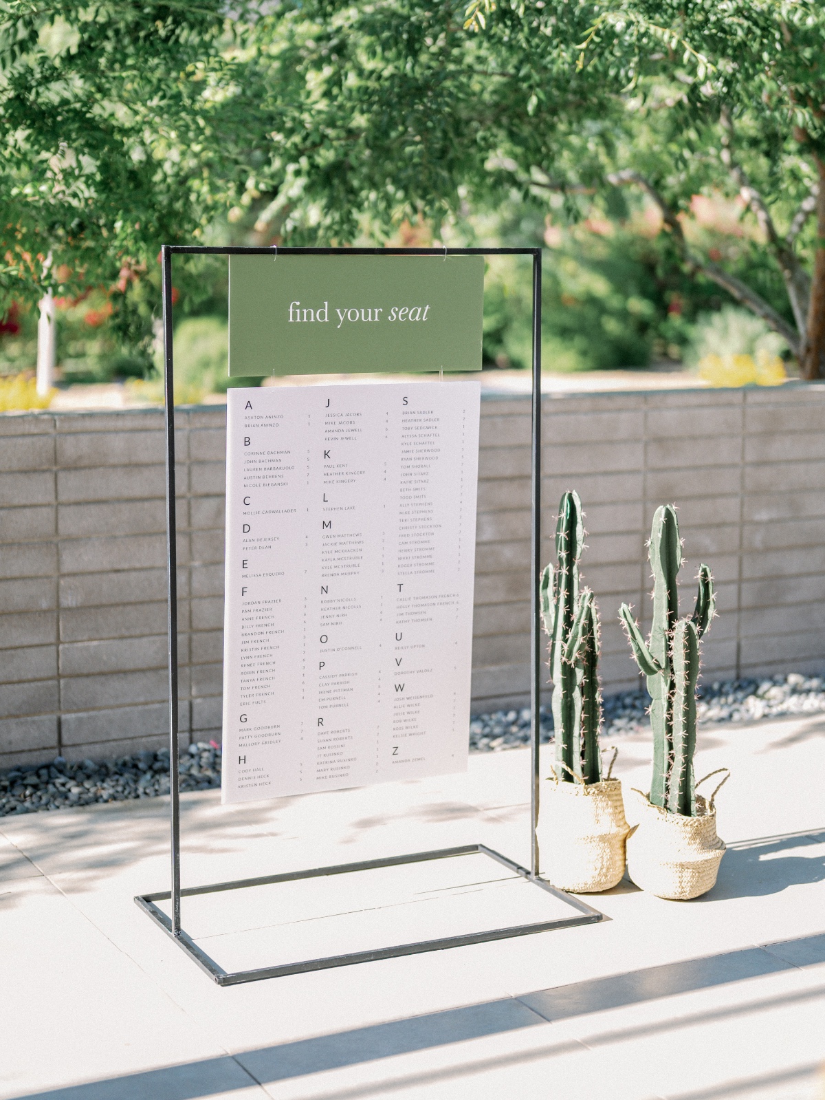 Olive green find your seat" seating chart on modern stand