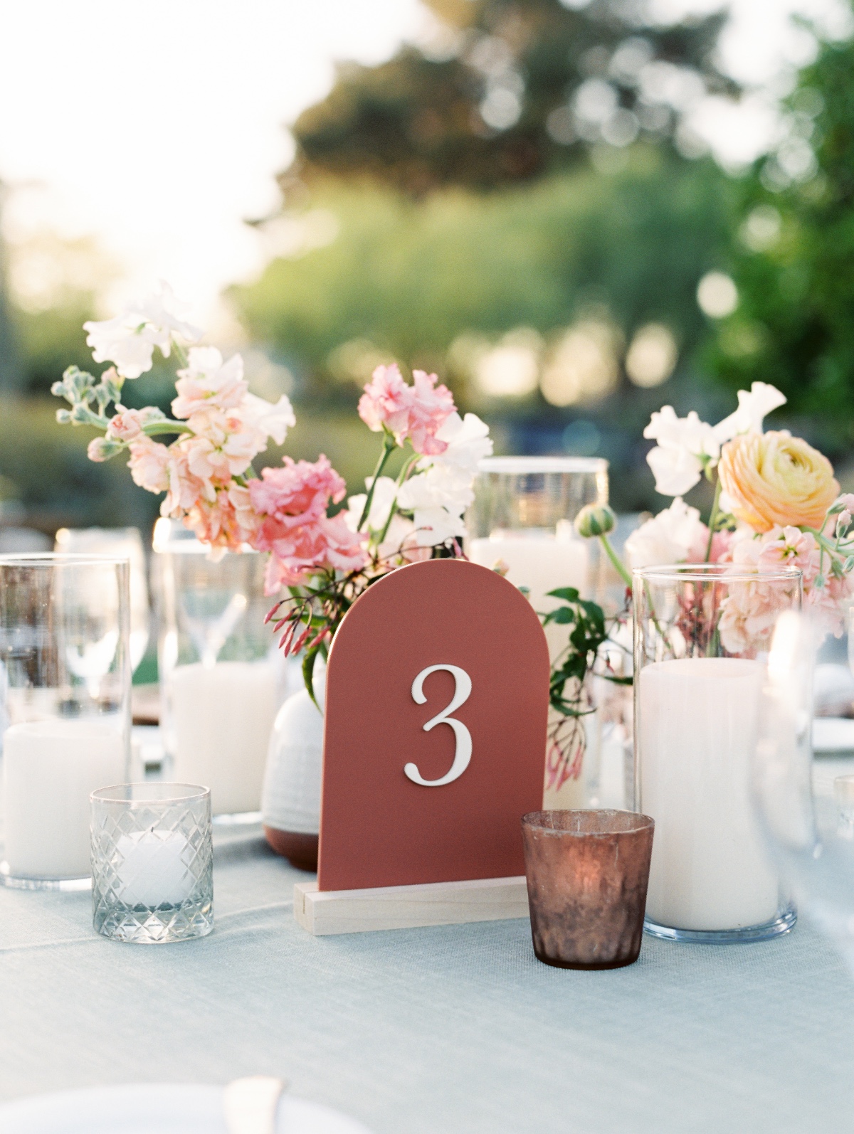 Modern curved wedding table number in dark orange color