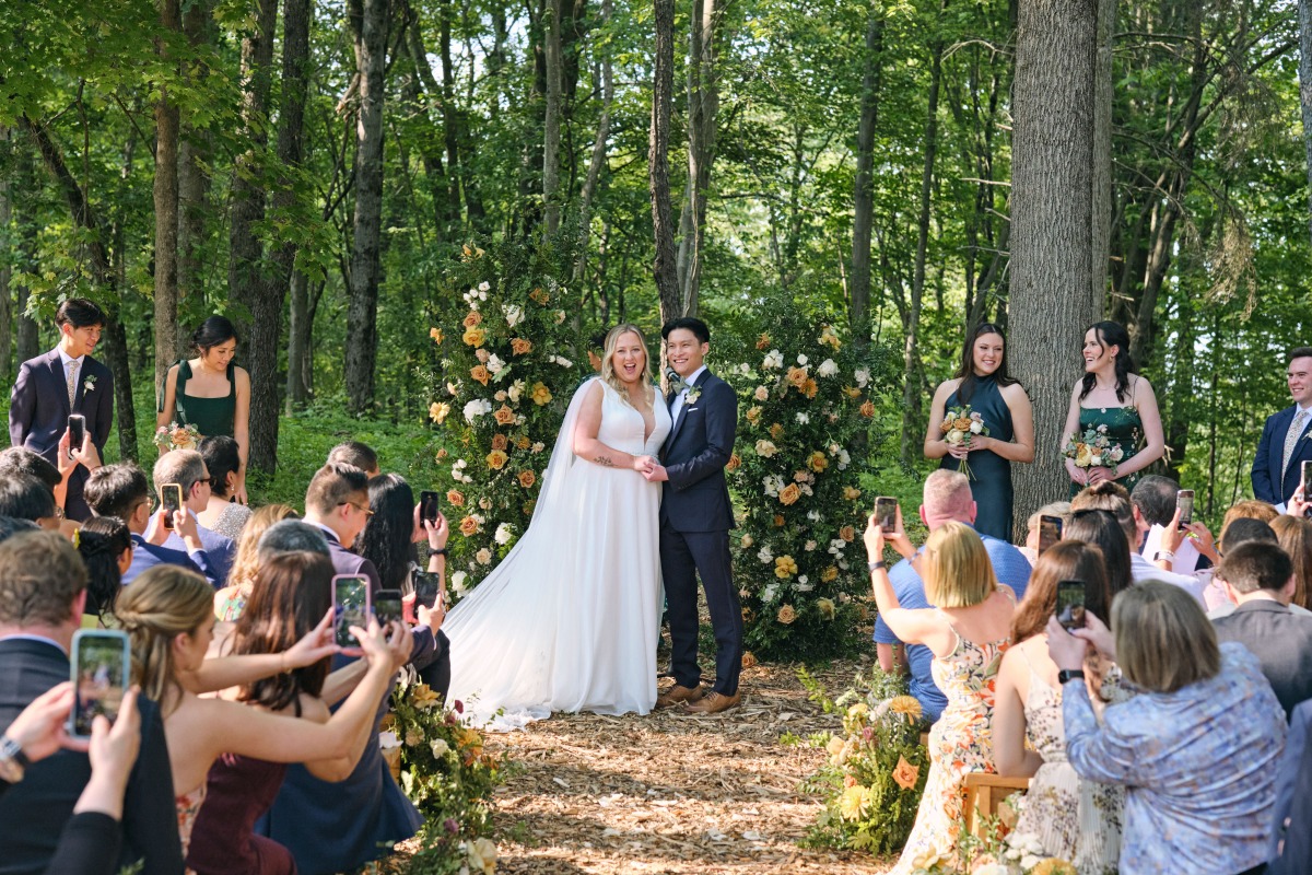 Social media moment during outdoor wedding ceremony 