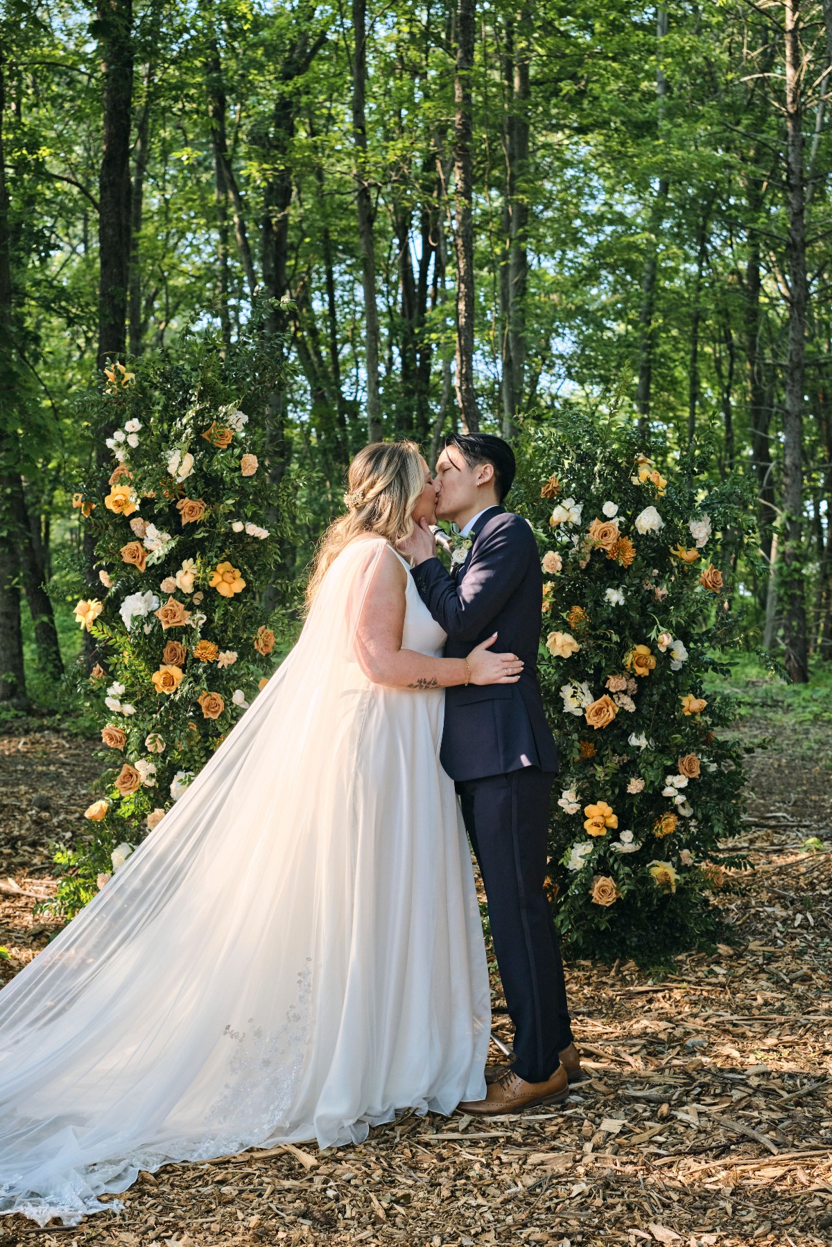 Romantic first kiss at New York wedding ceremony in forest