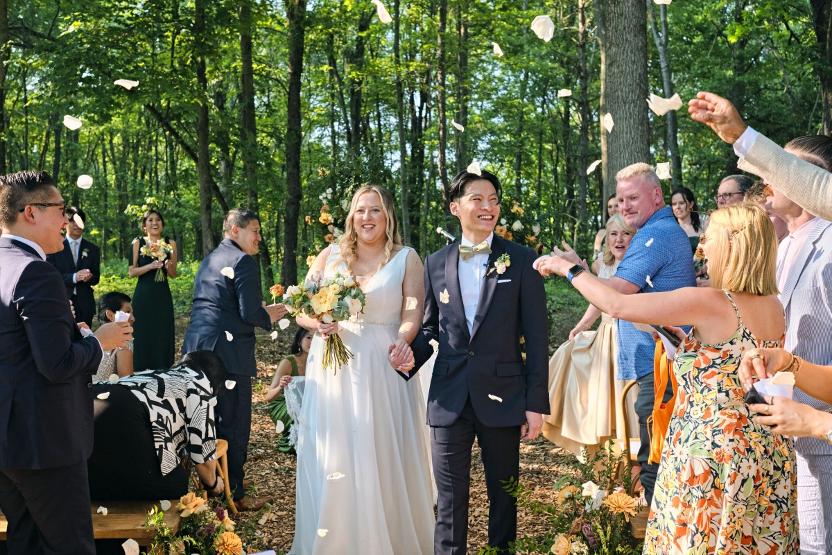 Guests throwing flowers at sustainable New York wedding 