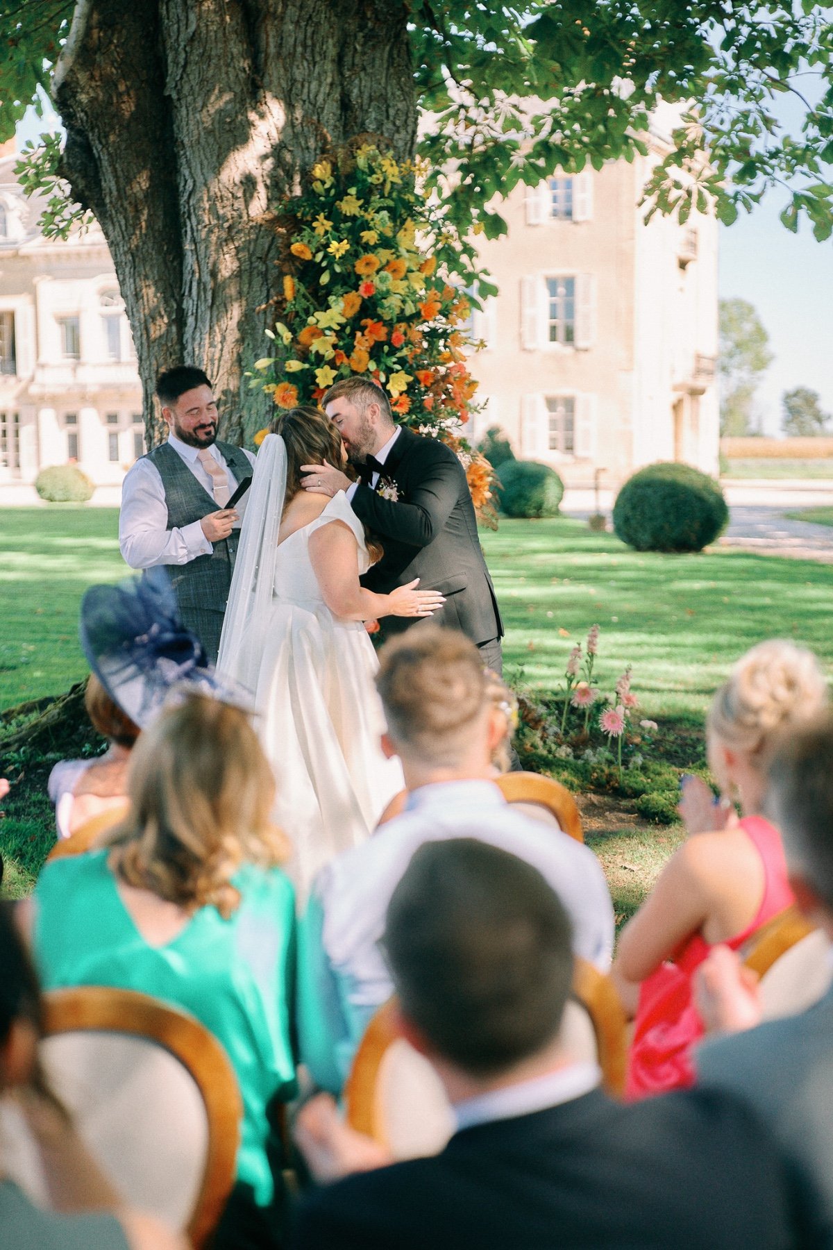 First kiss at French outdoor wedding ceremony