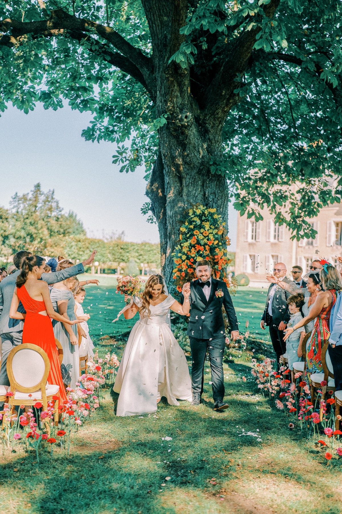 Newlyweds cheer at colorful French wedding ceremony