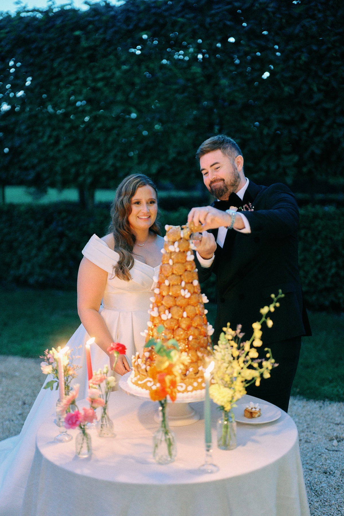 Bride and groom assemble croquembouche
