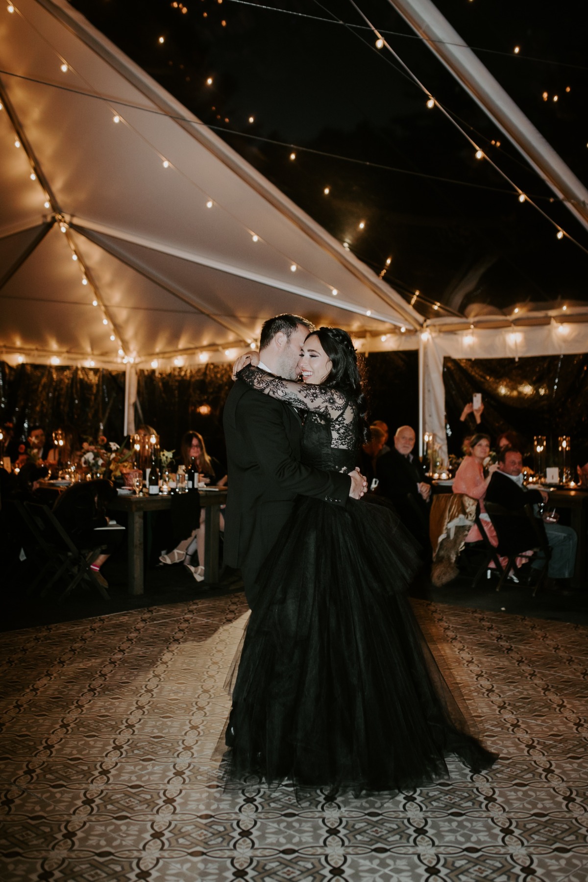 Moody and romantic first dance under string lit tent 
