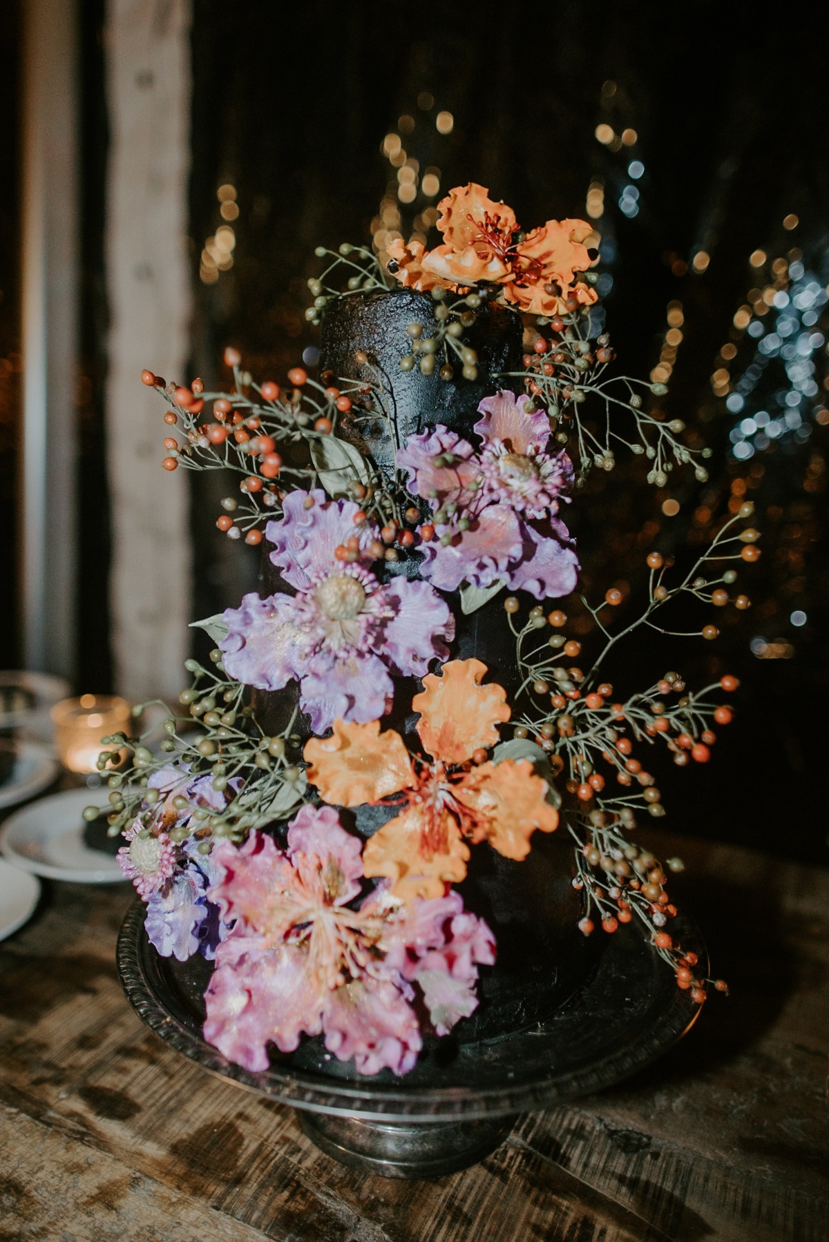 Black buttercream wedding cake with pastel floral details