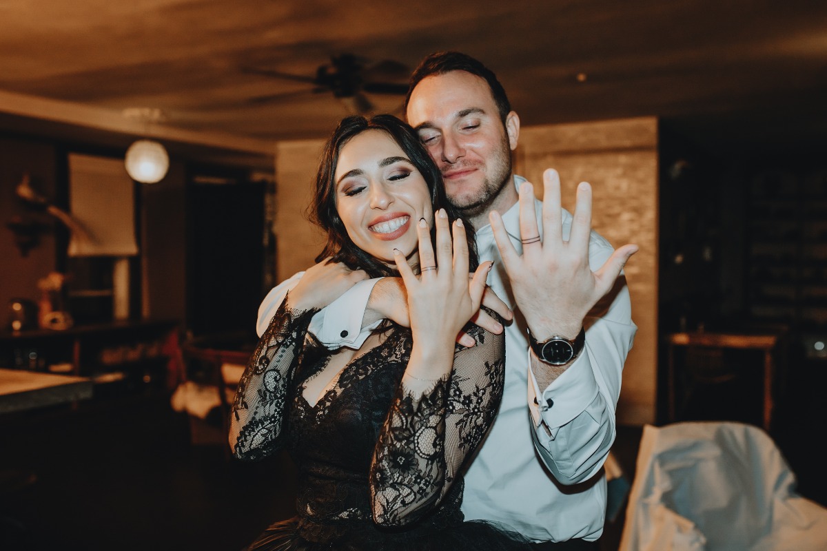 Romantic and alternative wedding couple with ring fingers tattooed 