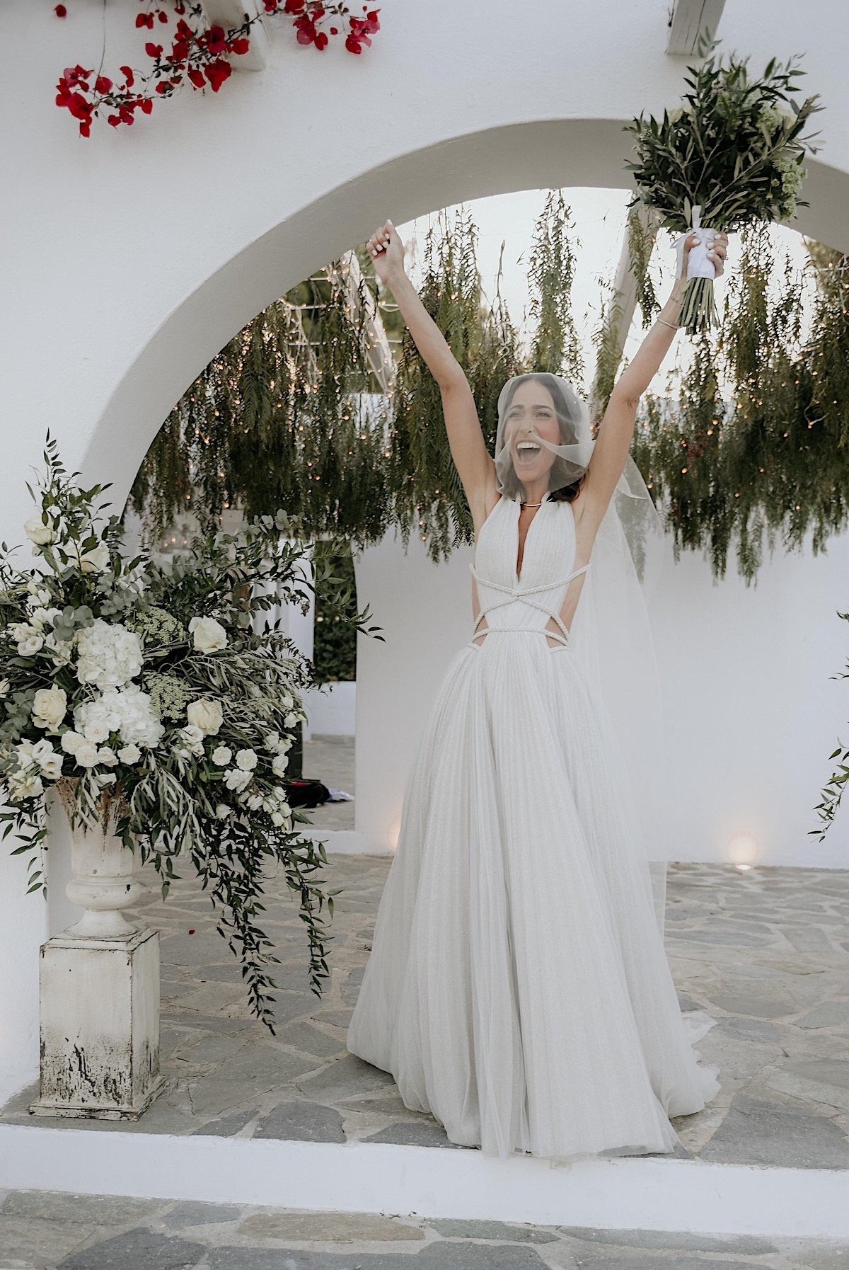 Greek bride cheering after romantic wedding ceremony