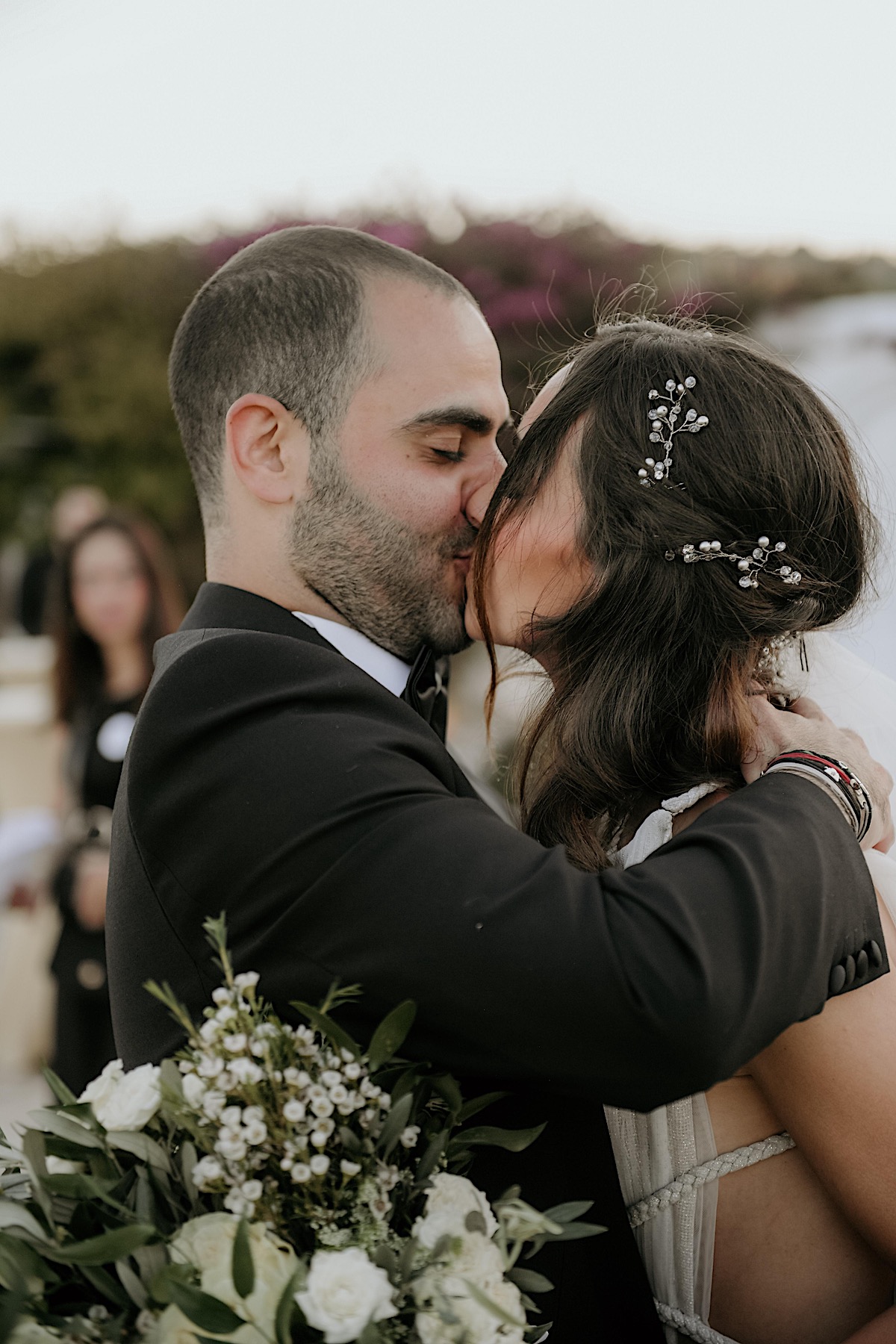 Romantic first kiss at destination wedding ceremony in Greece