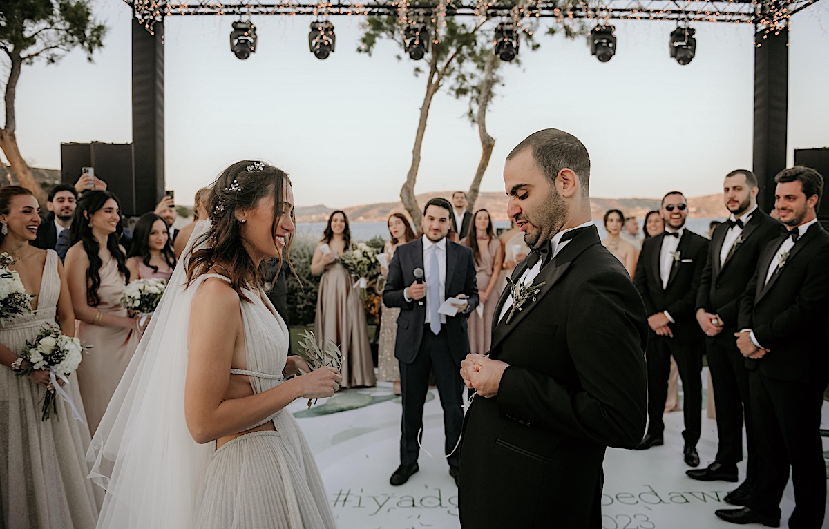Bride and groom doing traditional olive branch ceremony