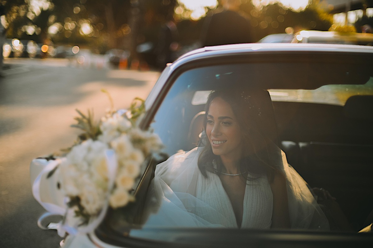 Destination wedding bride in Greece with vintage sports car