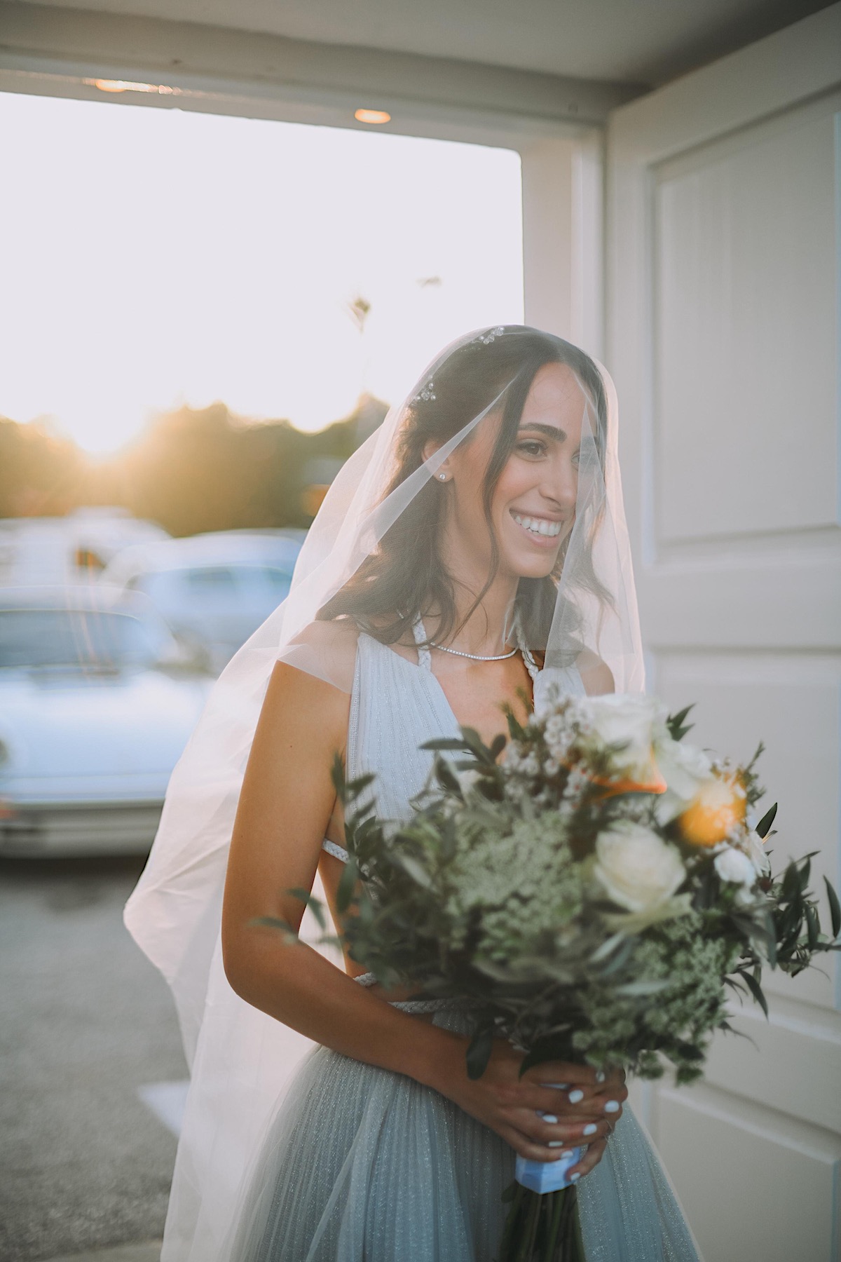 Gorgeous Greek bride in modern boho wedding dress and veil 