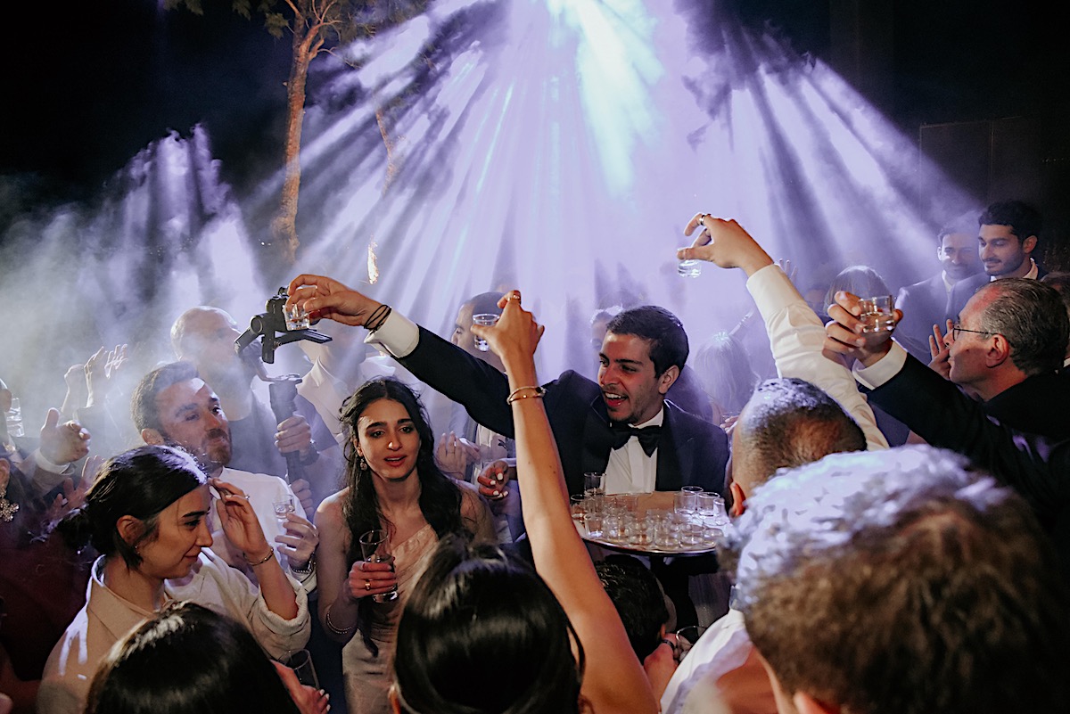Groomsmen doling out shots at wild wedding dance floor 