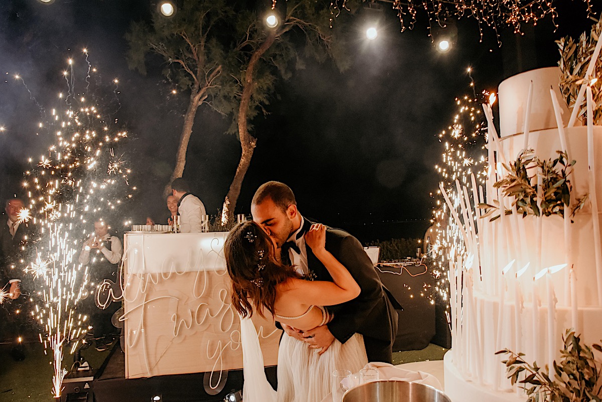 Dazzling sparkler candles kiss photo at epic cake cutting