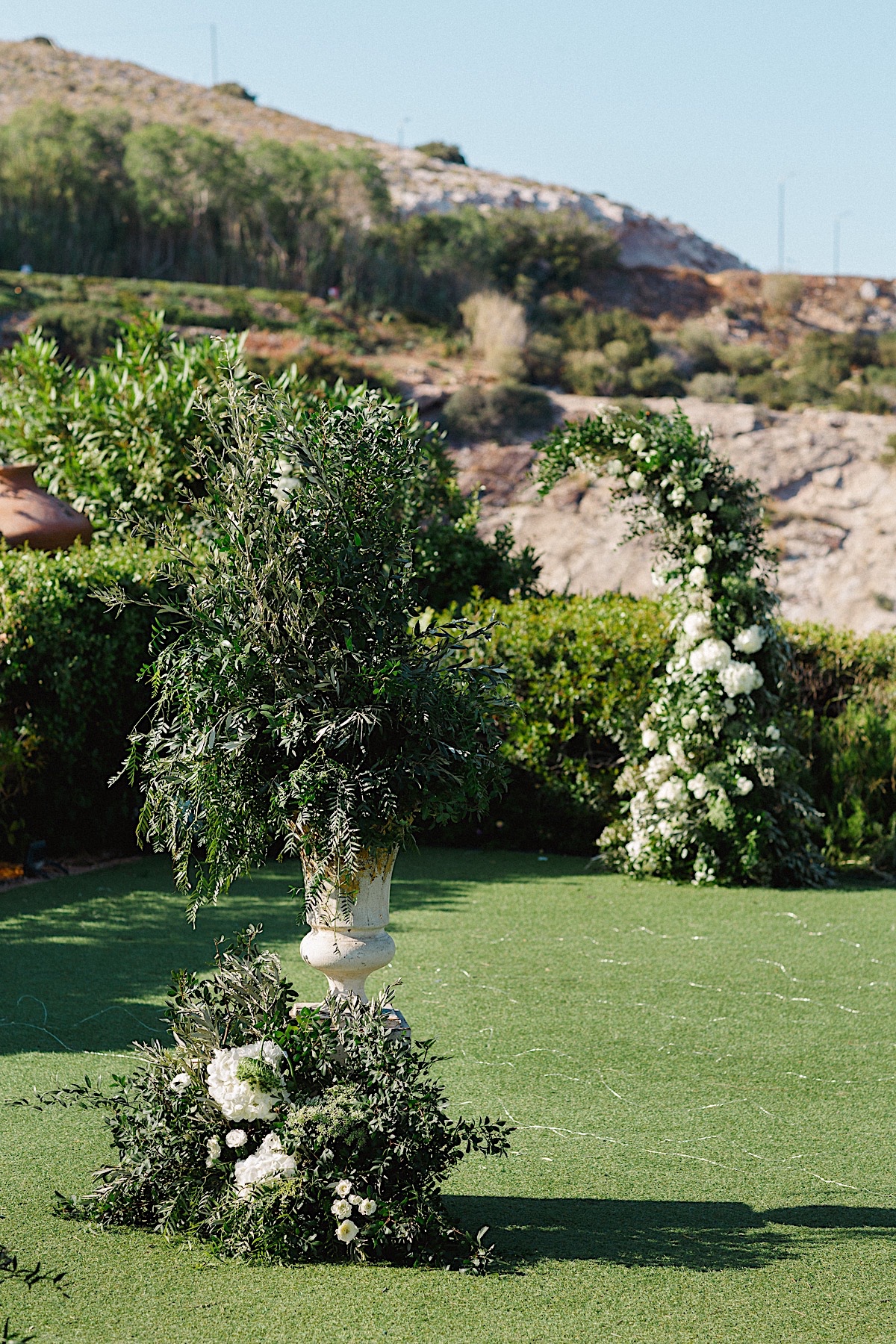 Avant garde wedding ceremony flowers with olive branches