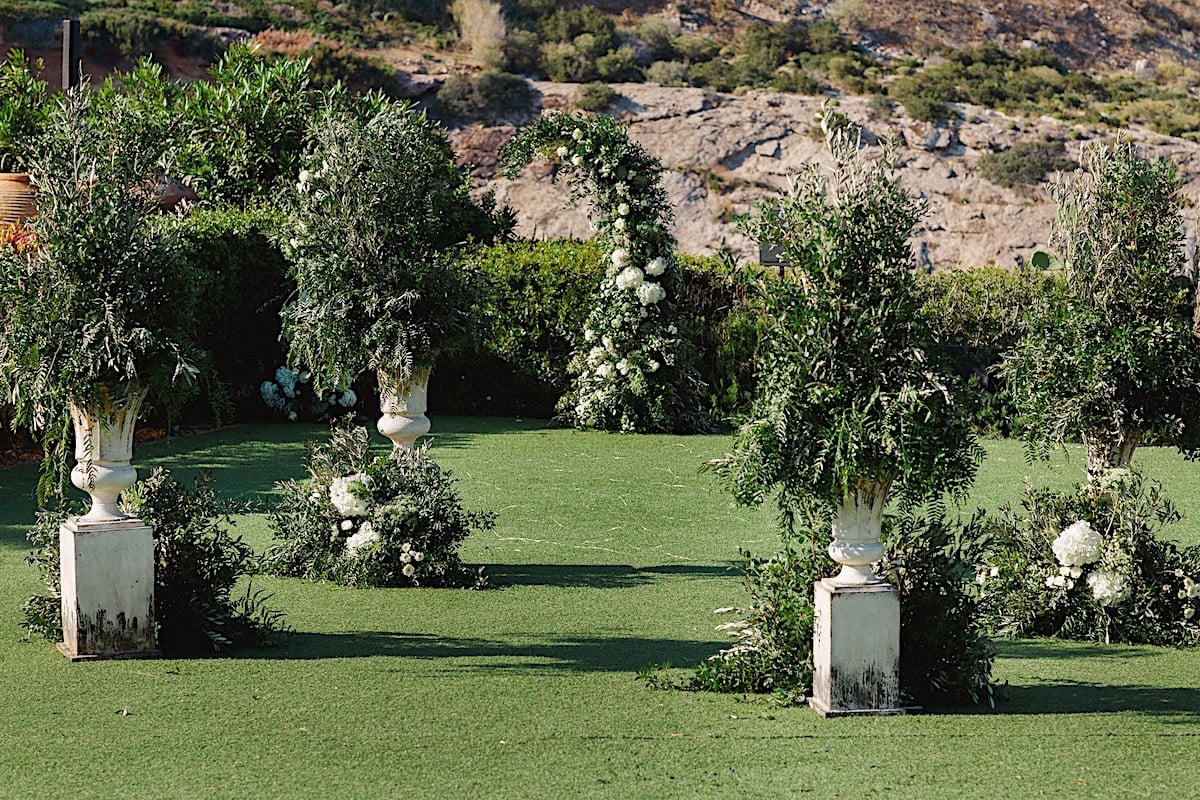 Modern avant garde wedding ceremony flowers and greenery