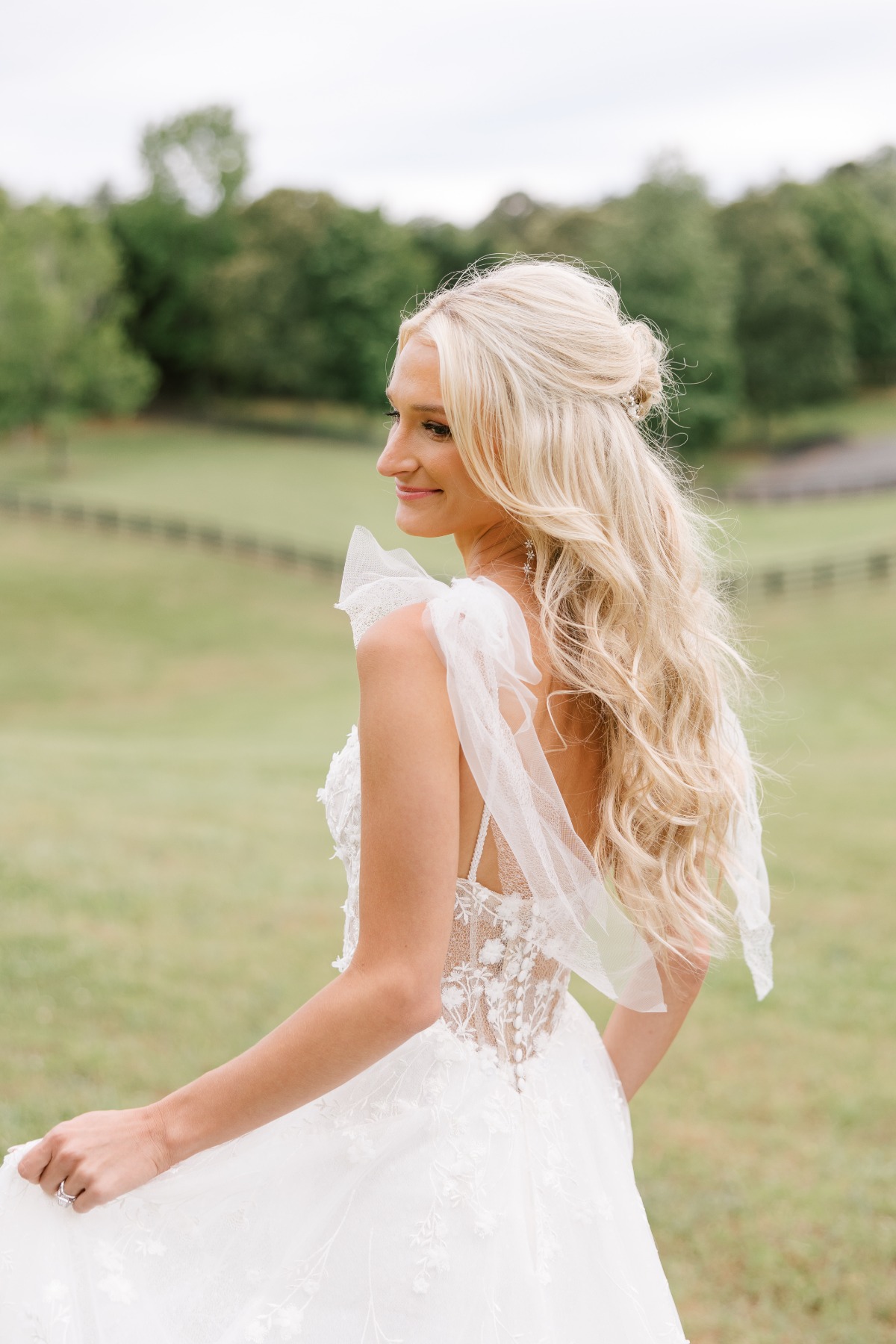 Bride in romantic floral lace Martina Liana gown with bows