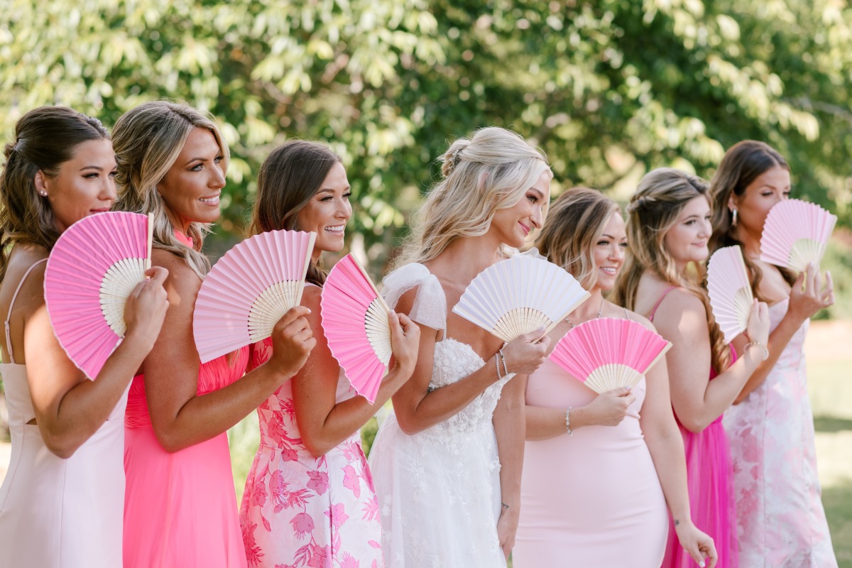 Bride and bridal party fans for summer wedding heat 