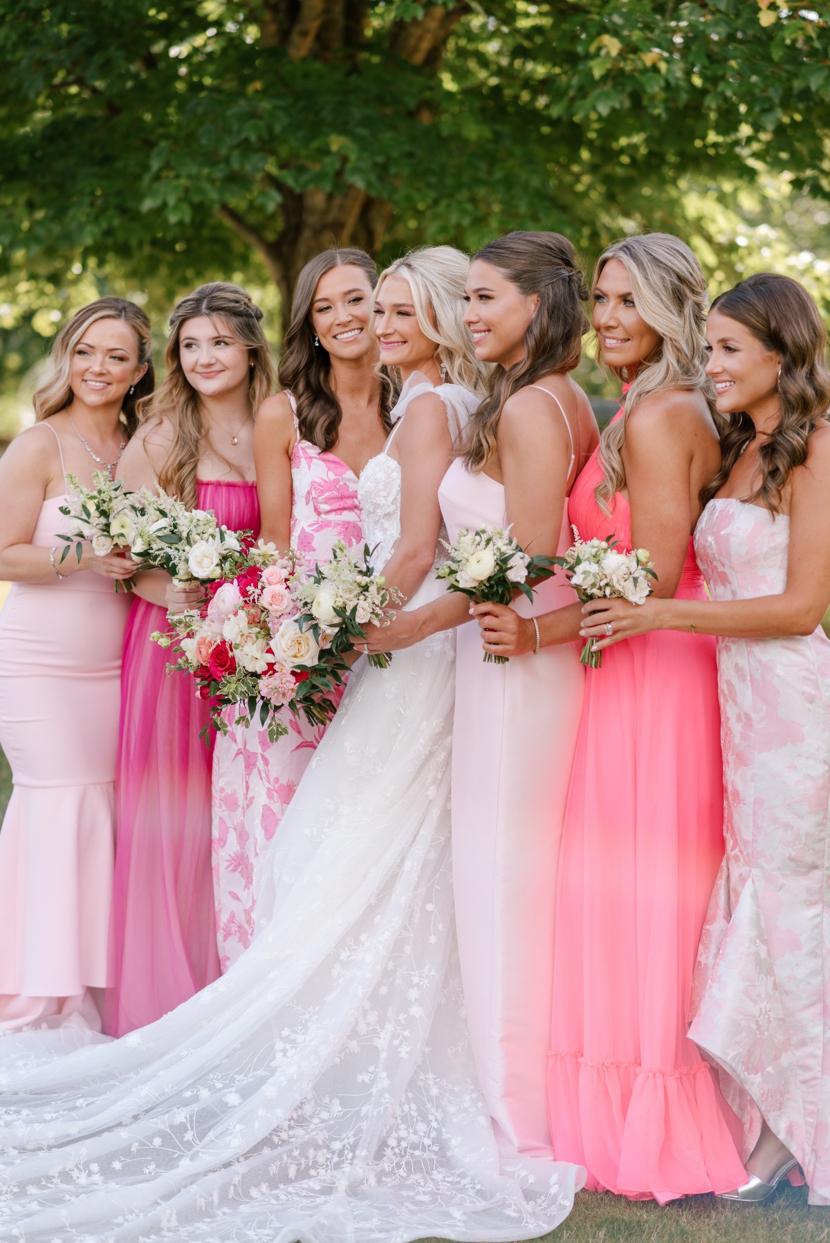 Bride and bridesmaids in mix and match pink floral dresses