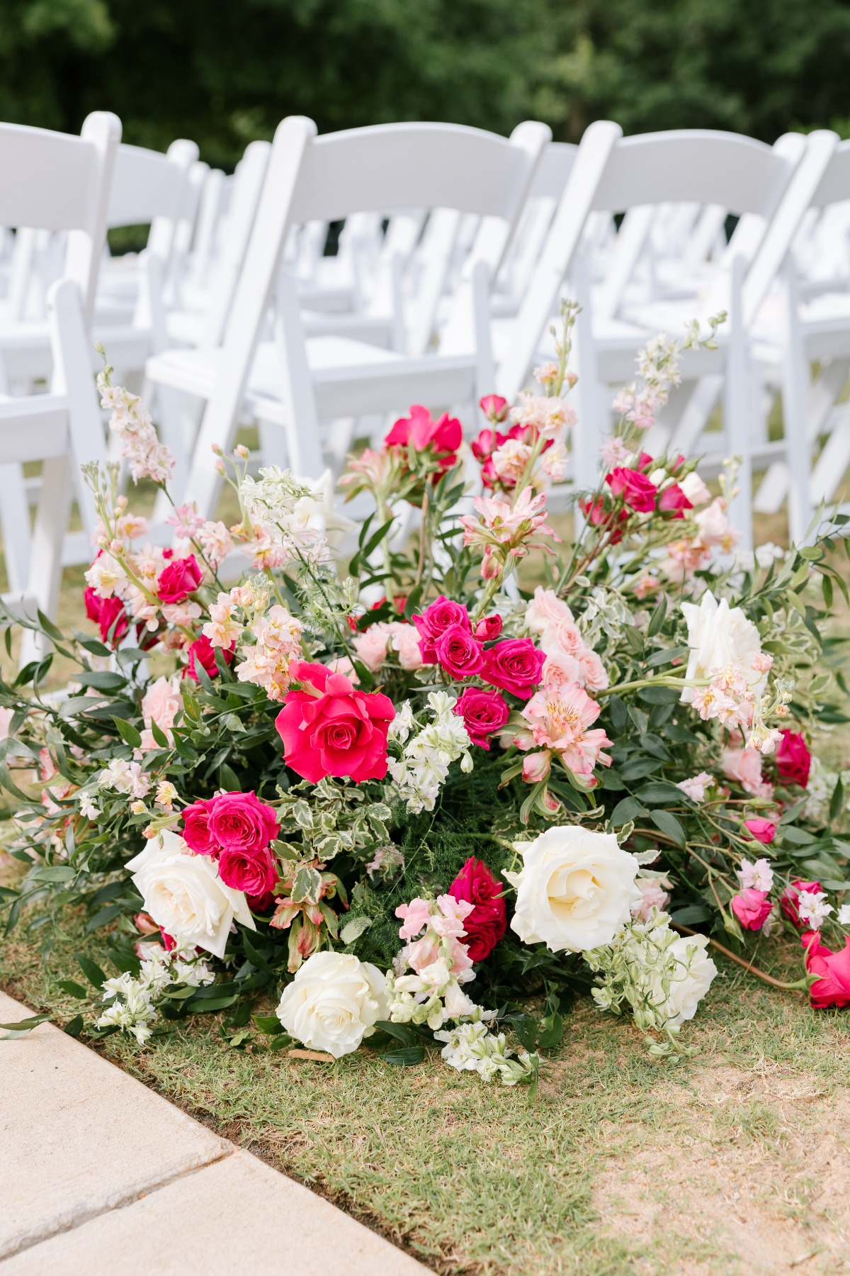 Hot pink and white floral centerpiece for ceremony aisle 