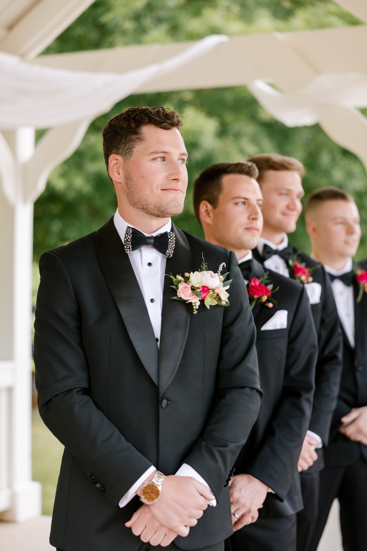 Modern stylish groom waiting at altar for bride to walk down 