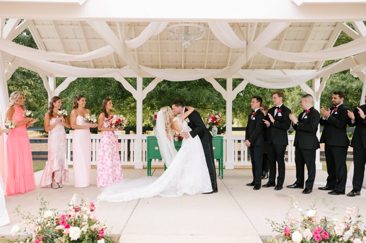 First kiss at romantic gazebo outdoor wedding ceremony 