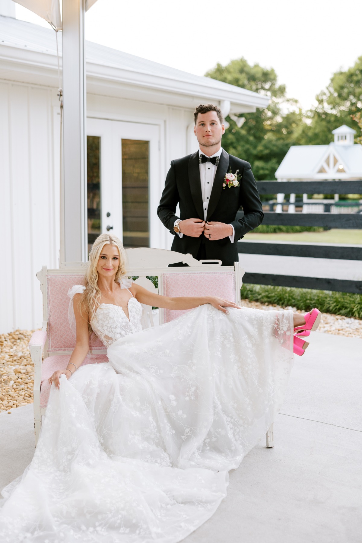 Stylish bride and groom at pink luxury barn wedding 