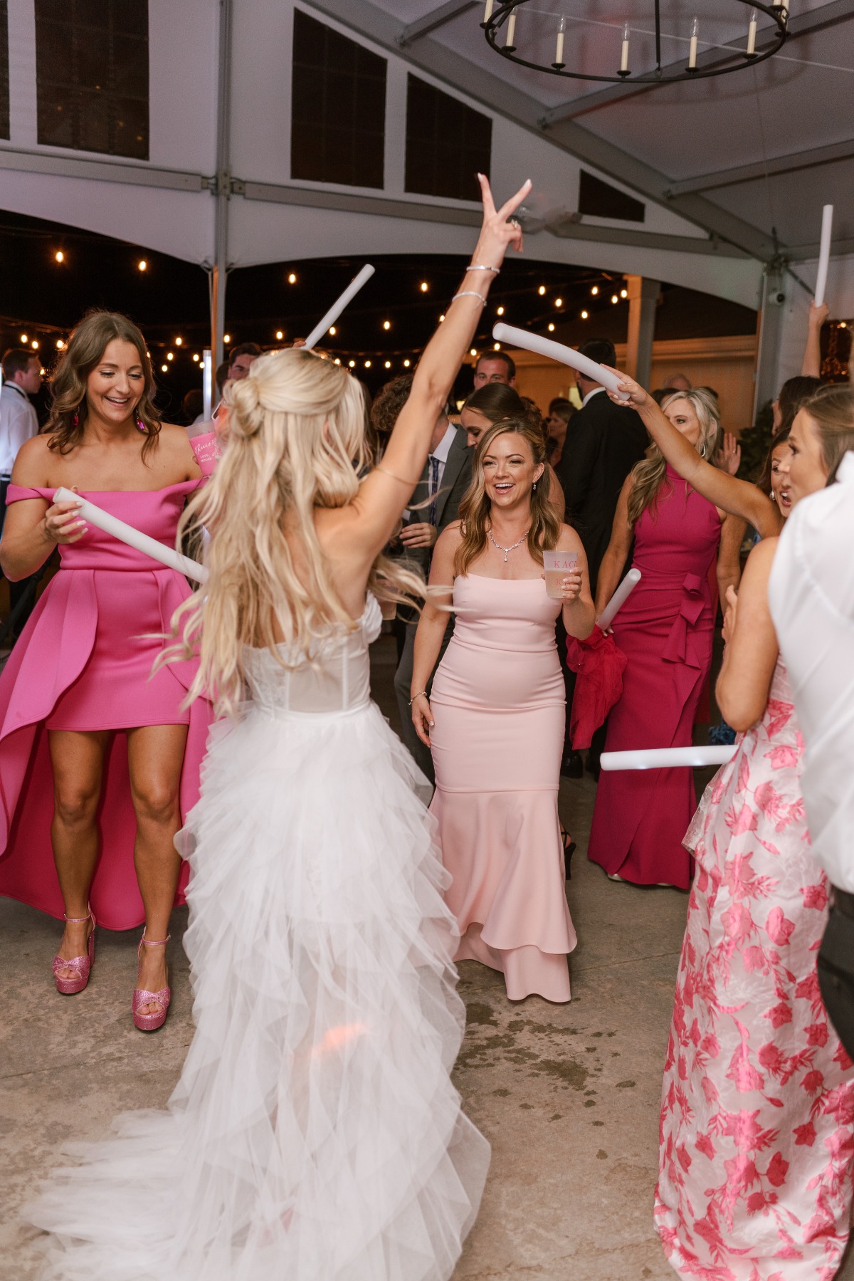 Bride dancing at reception in ruffled layered wedding dress