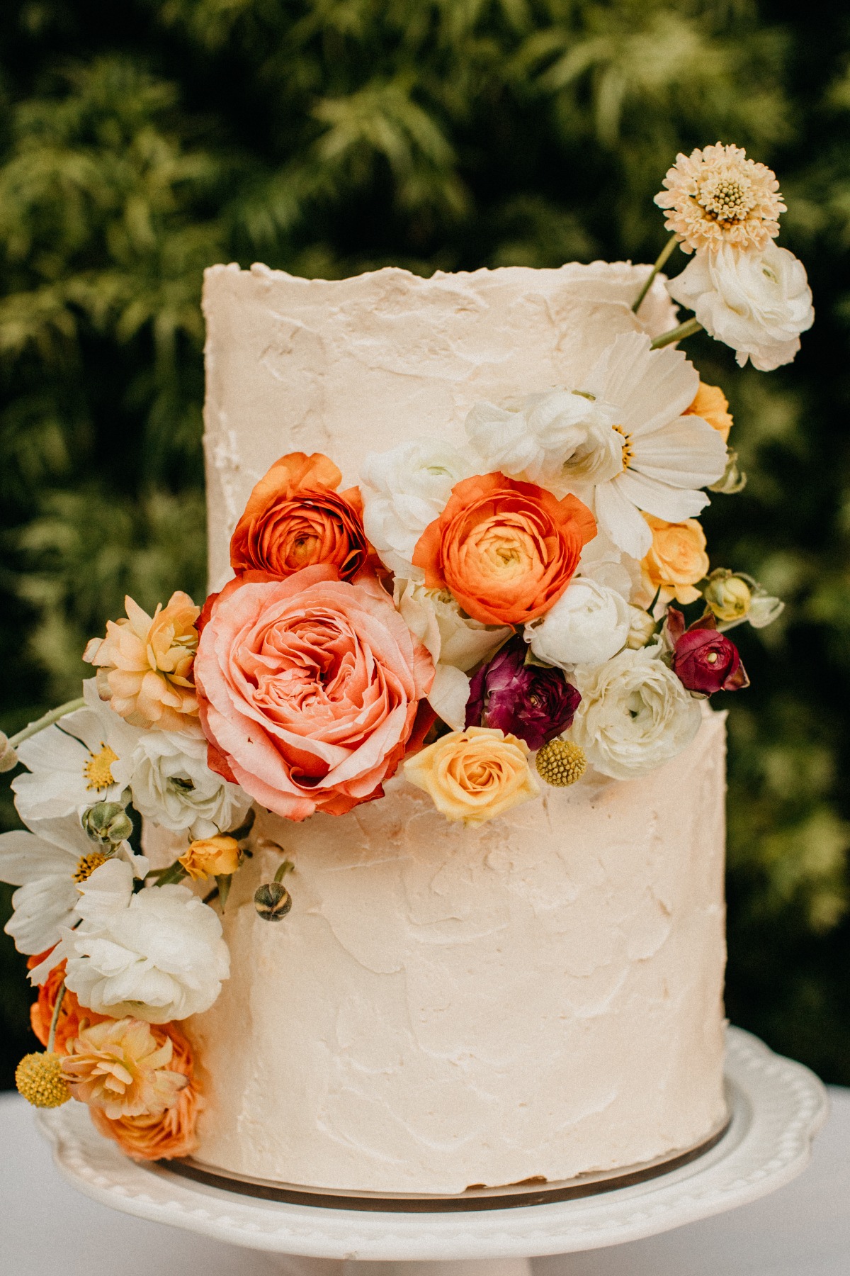 wedding cake with peach orange and white flowers