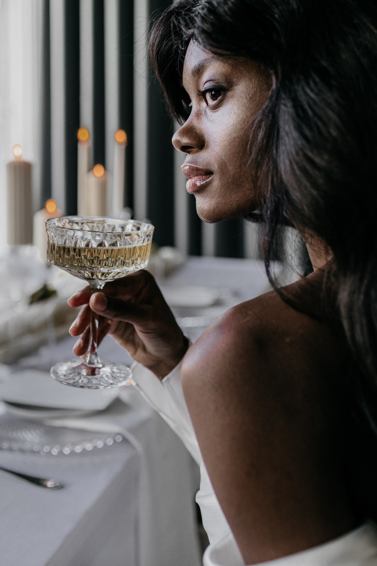 Bride sipping champagne at Swiss destination wedding shoot