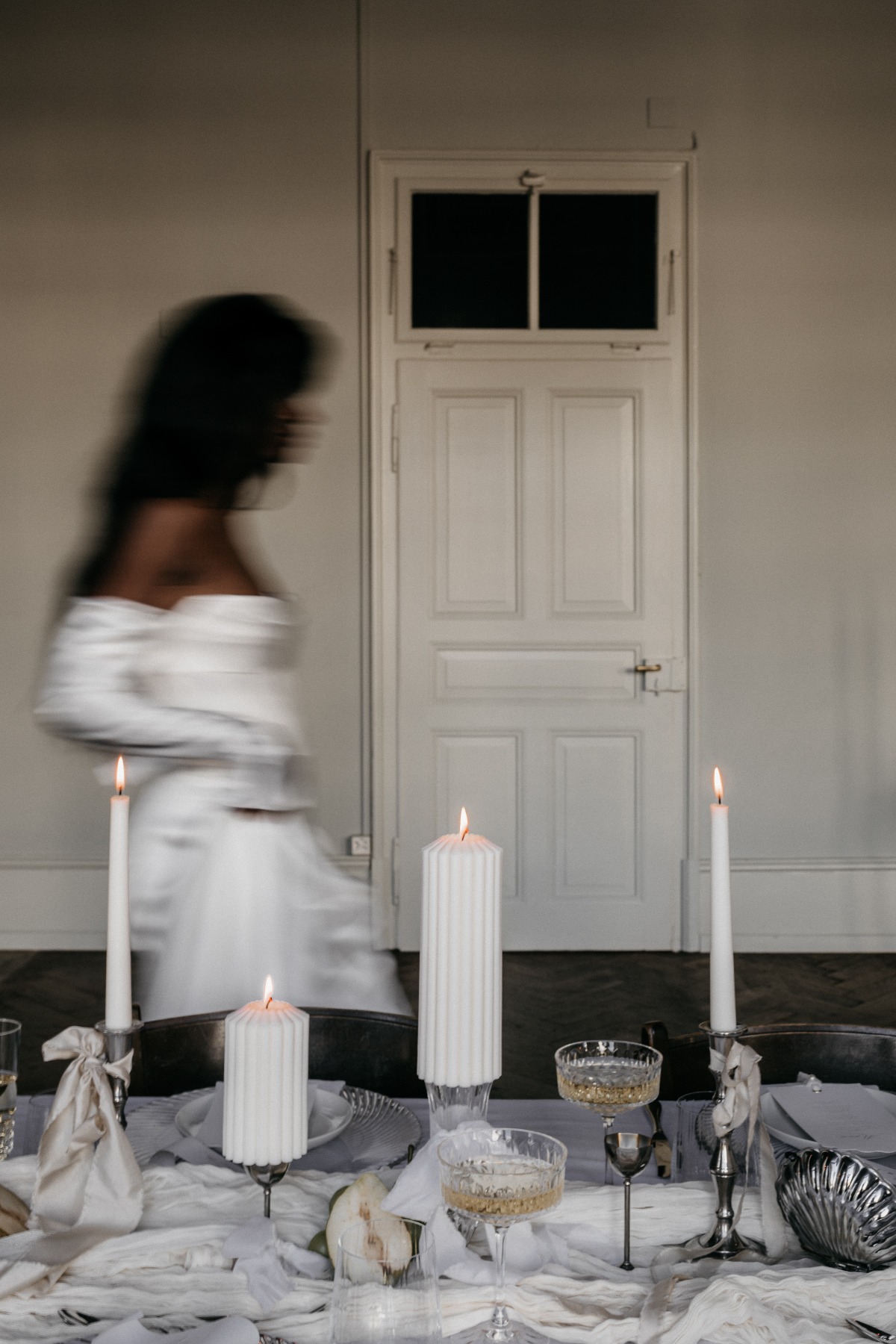 Modern moody reception table with tall candles and goblets