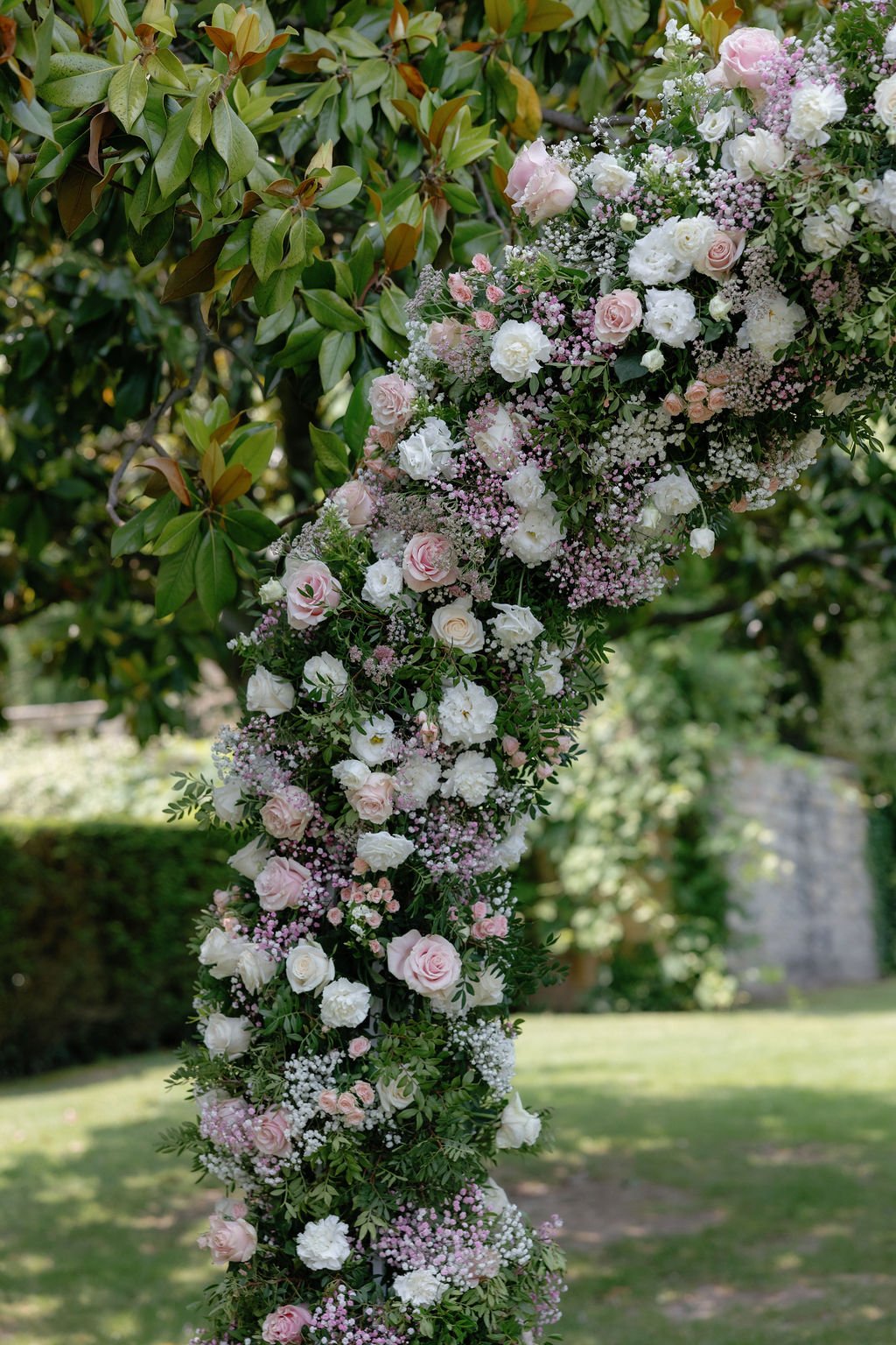 Pale pink and white rose arch with baby's breath accents 