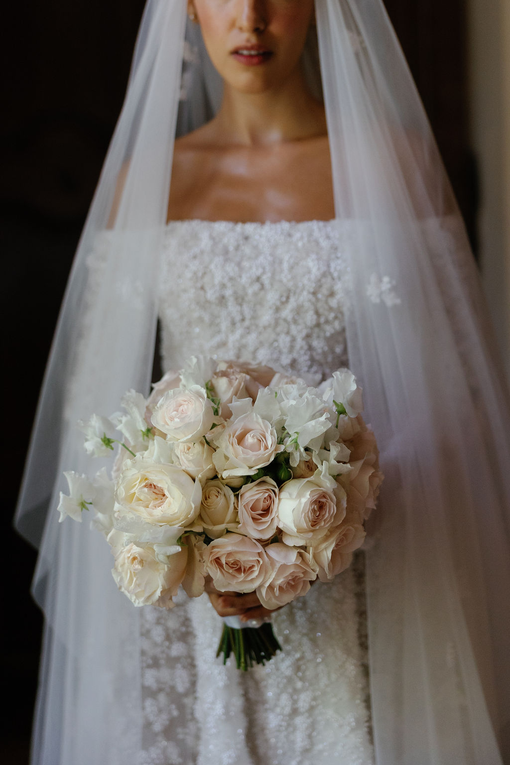 Bride in floral designer wedding gown that matches flowers