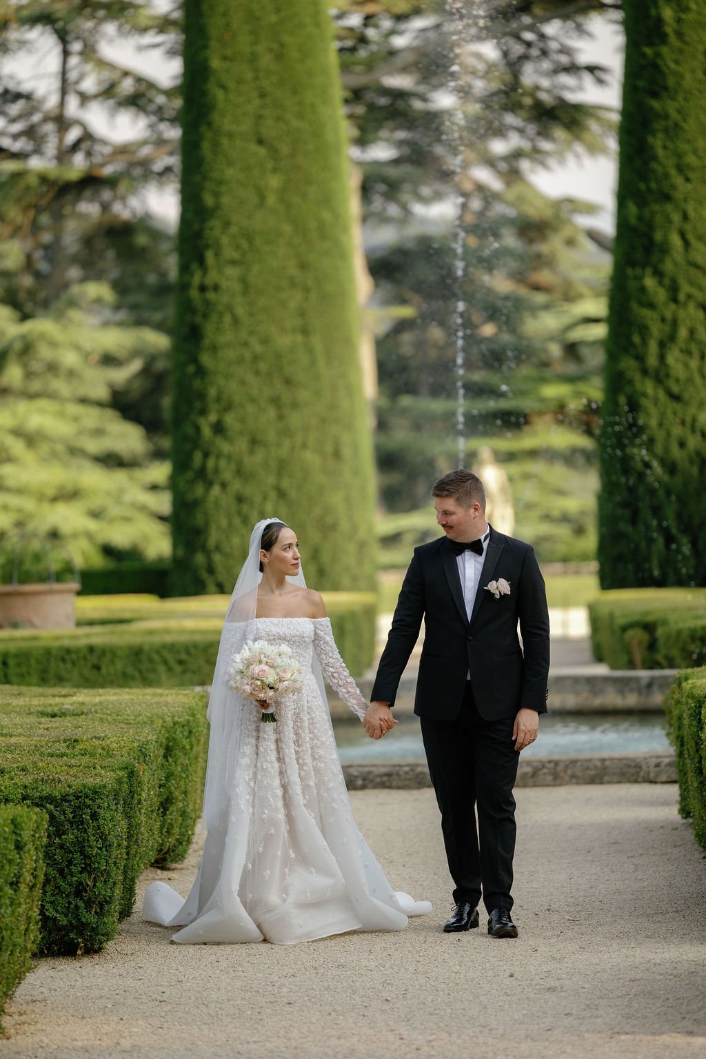 Newlyweds at French chateau garden at destination wedding