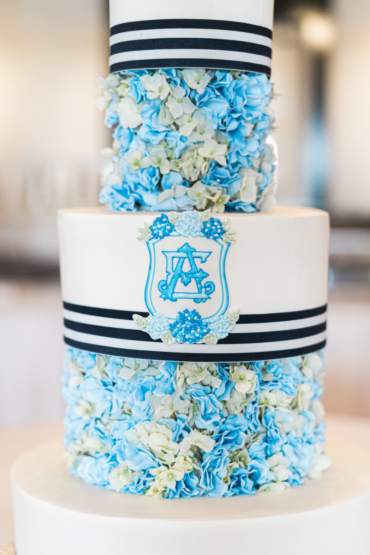 Blue hydrangea covered striped wedding cake 