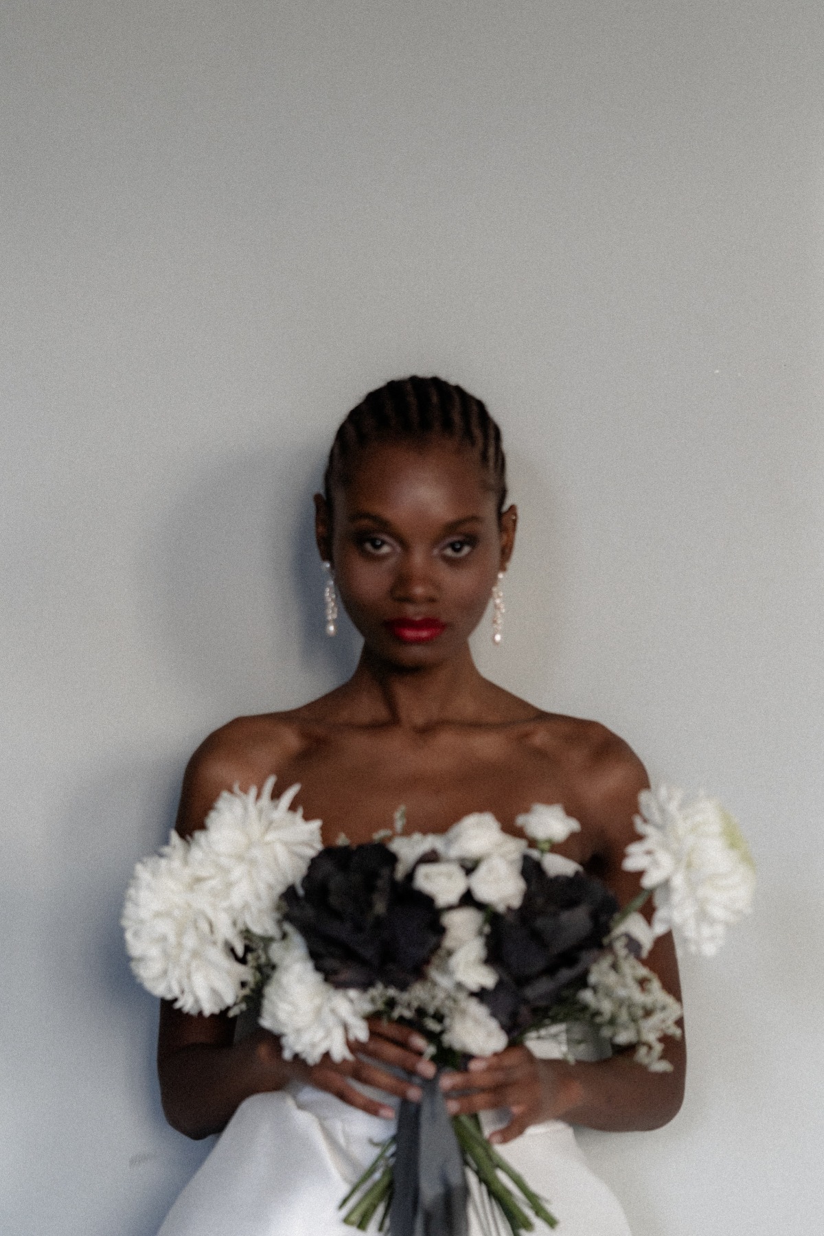 Moody modern Black bride with braided back hair style 
