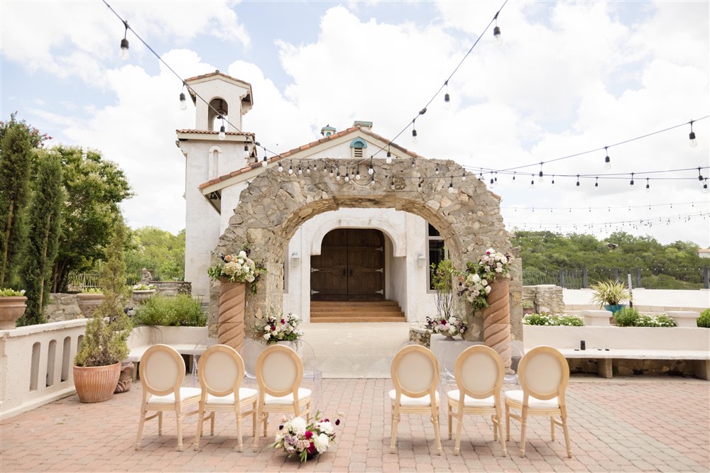 wedding ceremony with stone arch at villa antonia