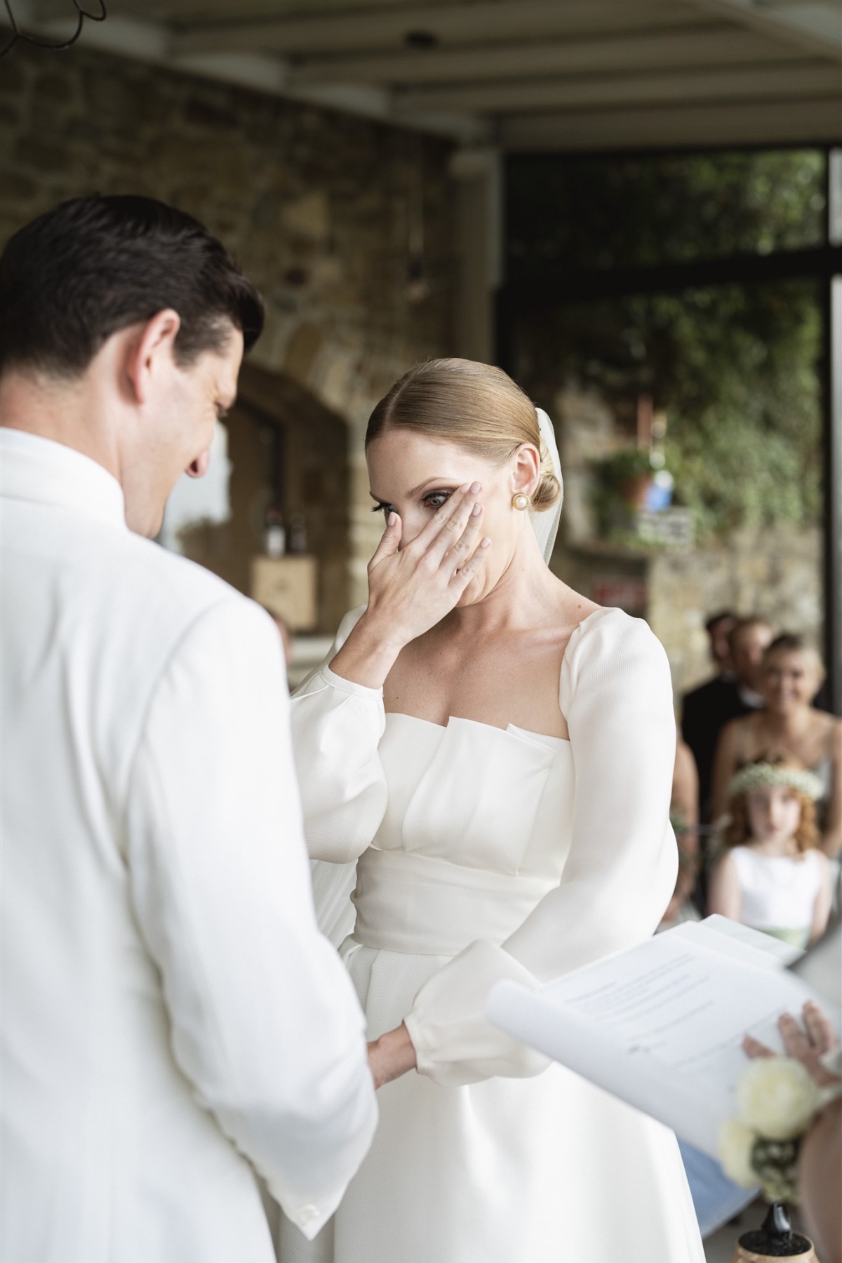 Bride crying at outdoor Italian villa wedding ceremony 