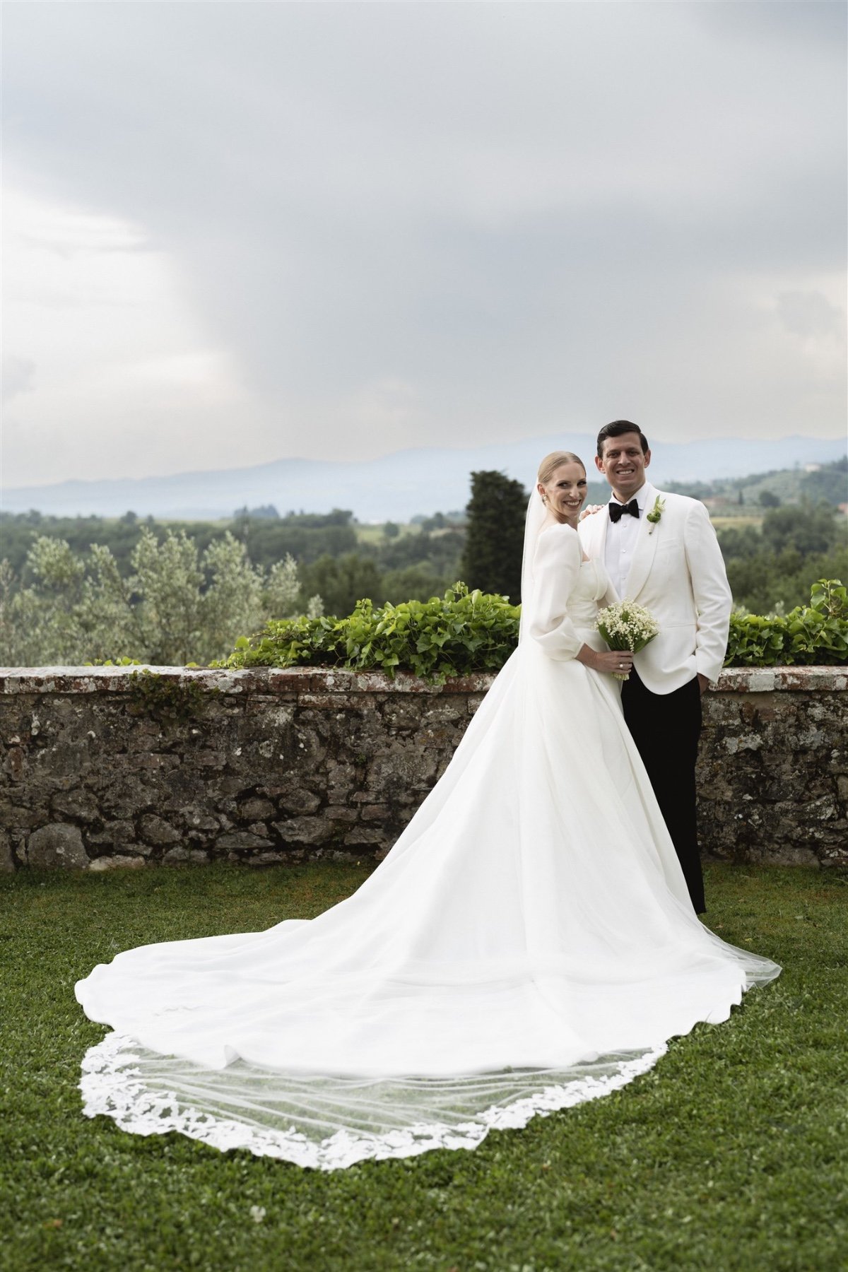 Romantic couple posing for portraits at Italian villa wedding 