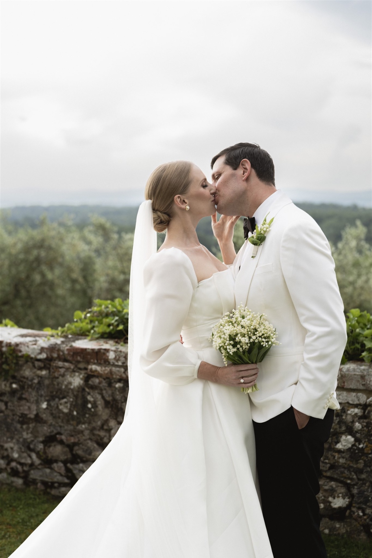 Romantic couple kissing at Italian villa wedding 