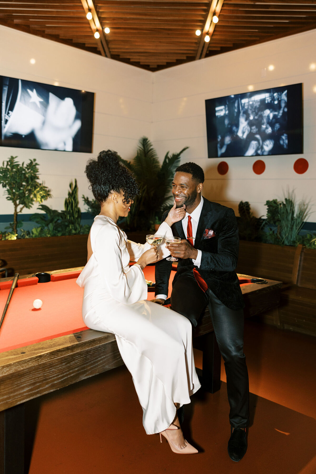 Bride and groom at billiards table