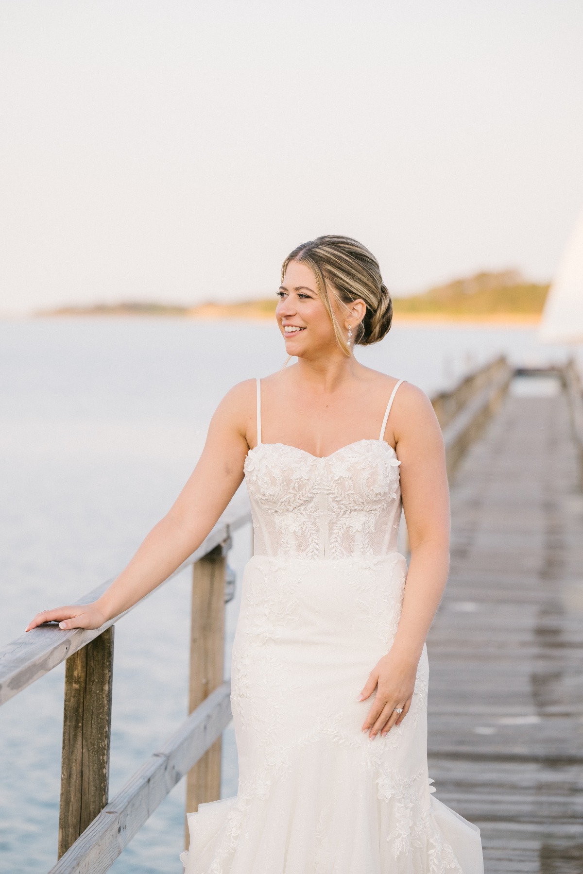 Bride changes into sleeveless dress for coastal reception 