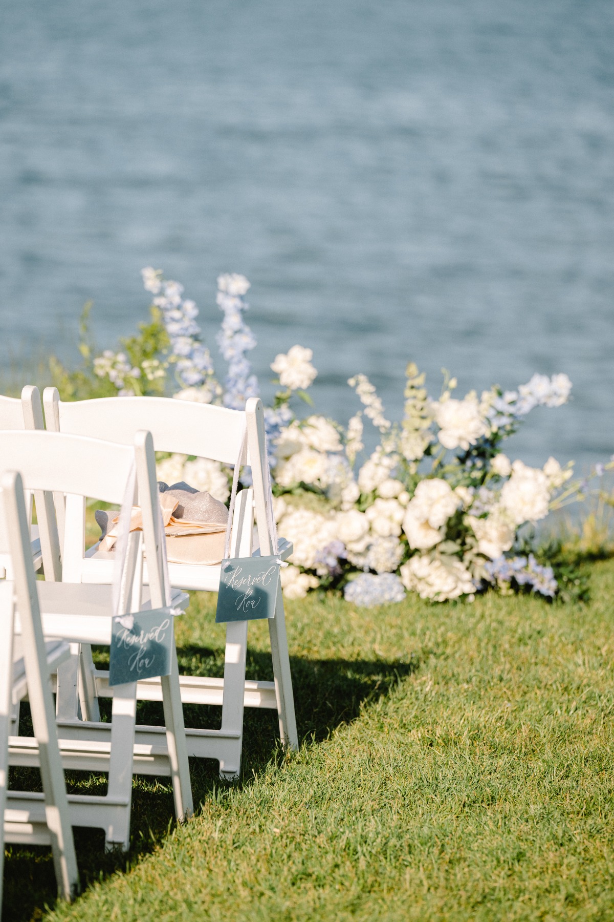 Simple white wooden folding chairs for wedding ceremony