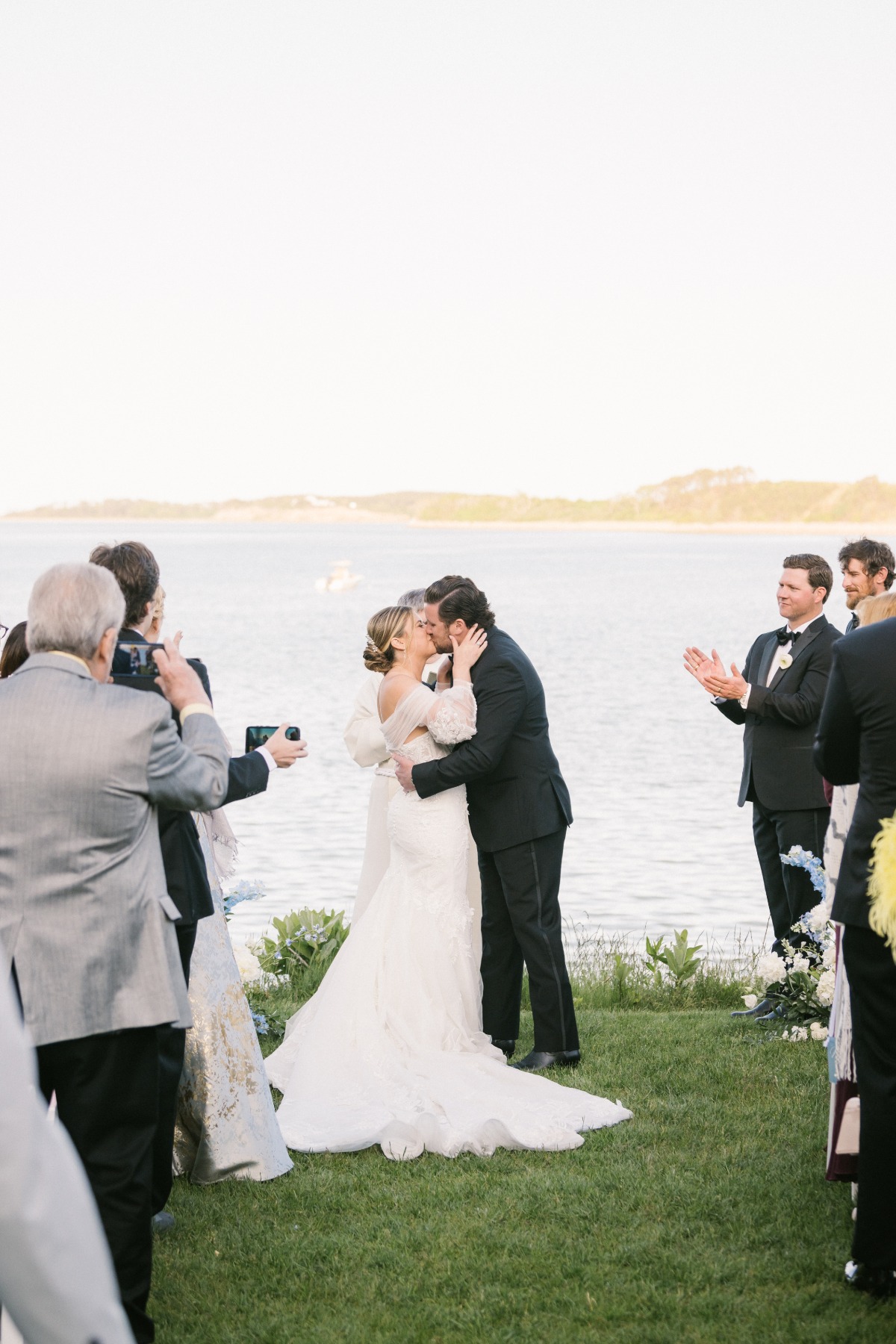 Elegant first kiss at seaside wedding ceremony in Cape Cod