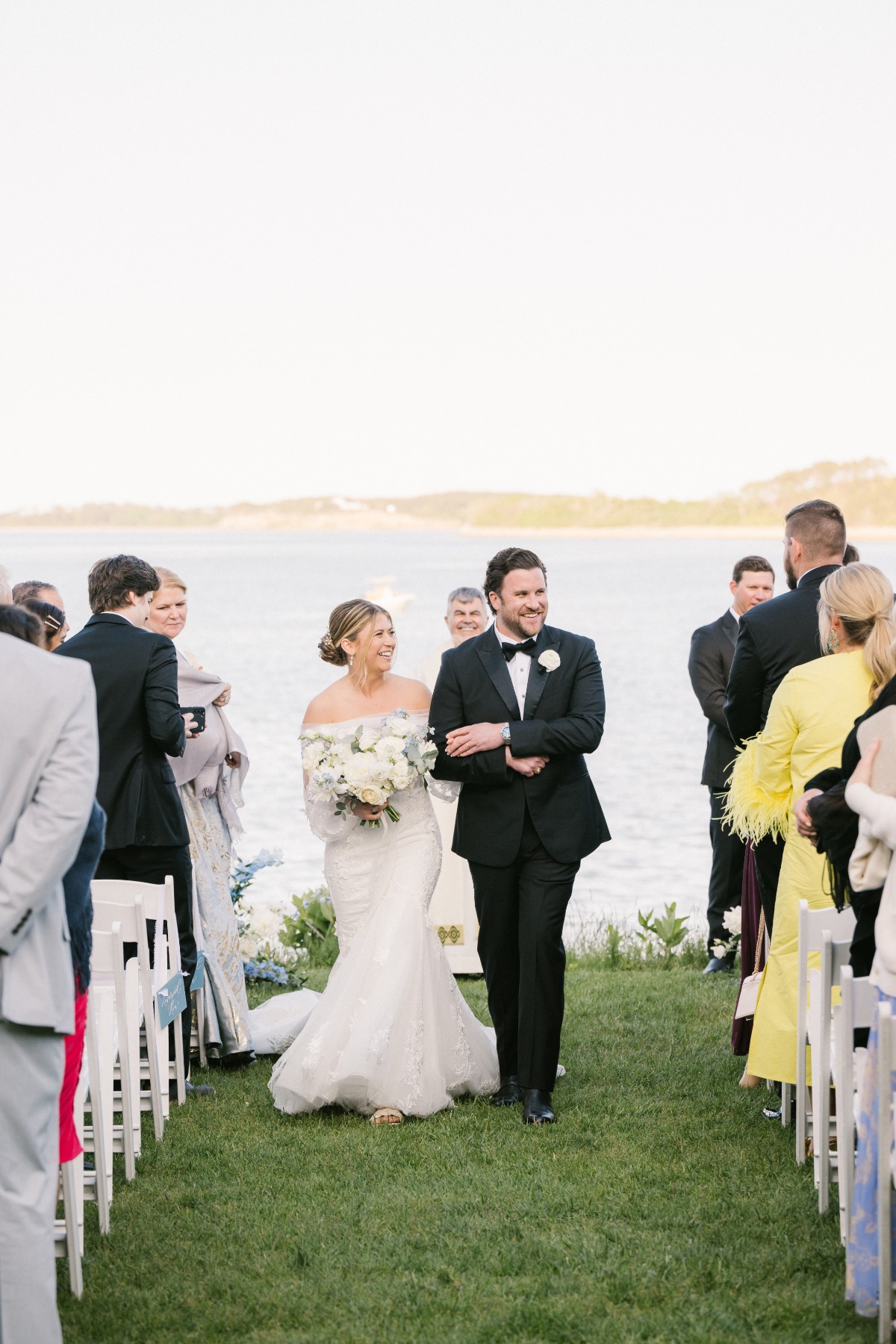Newlyweds walking down the aisle at seaside Cape Cod wedding