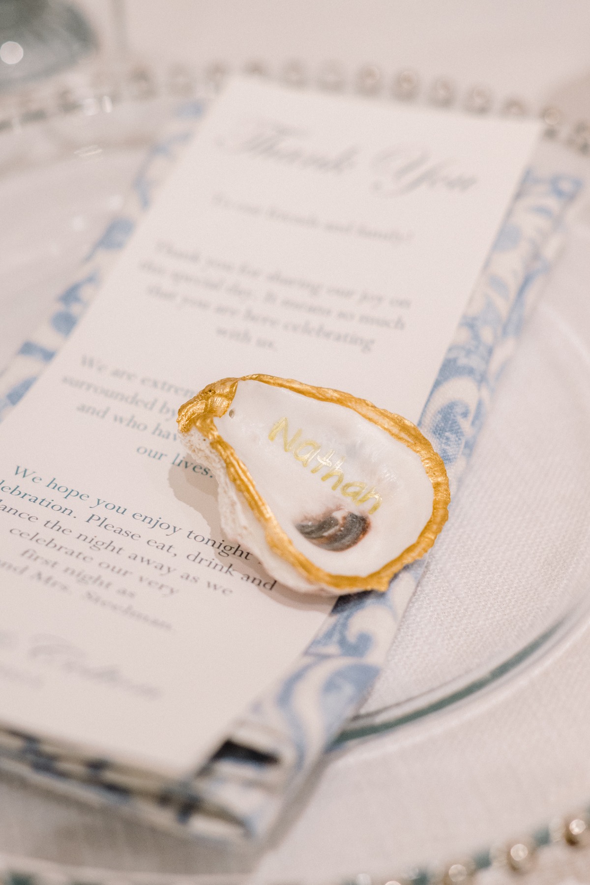 Custom DIY oyster shell place cards for wedding reception 