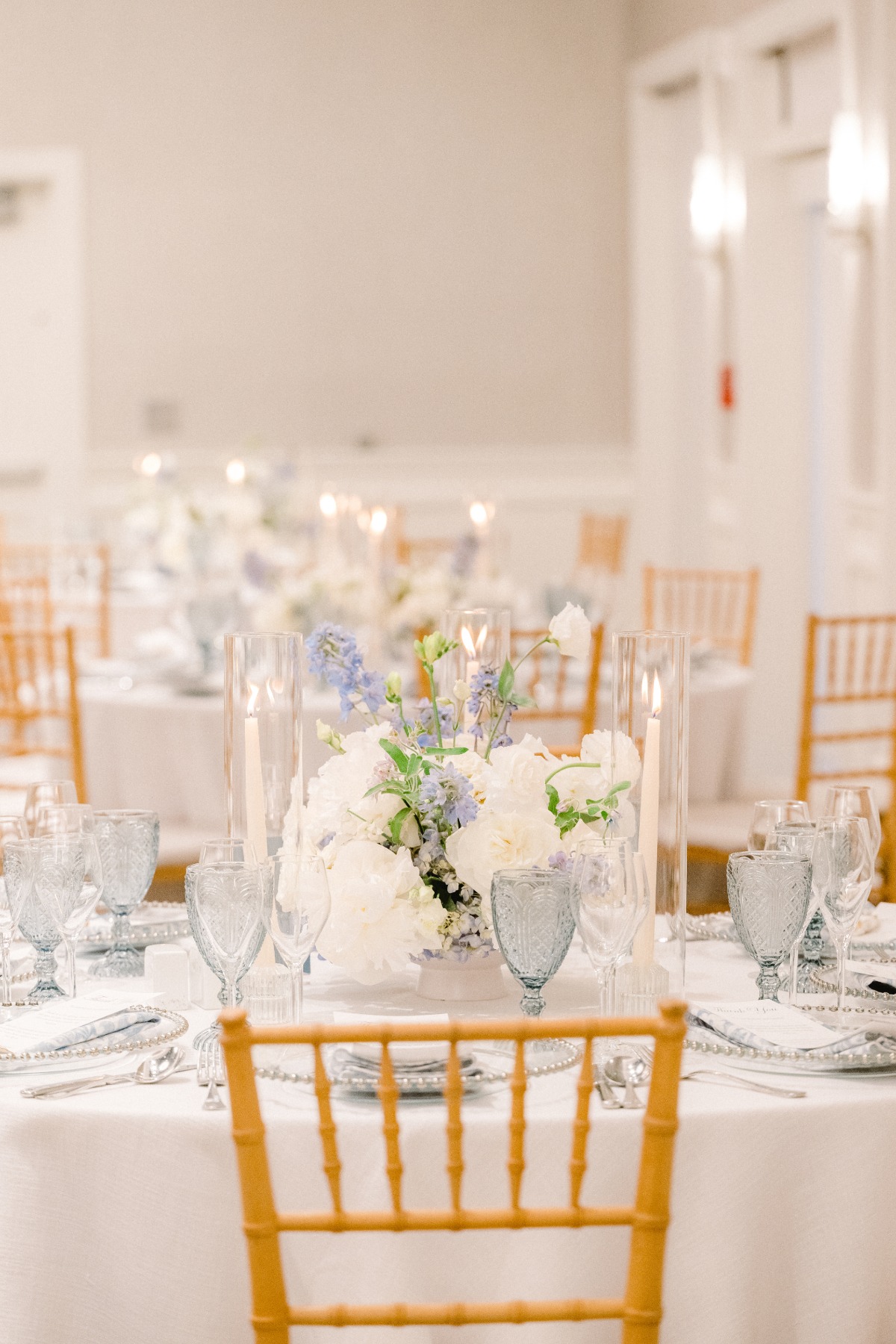 Timeless floral themed indoor reception with blue accents