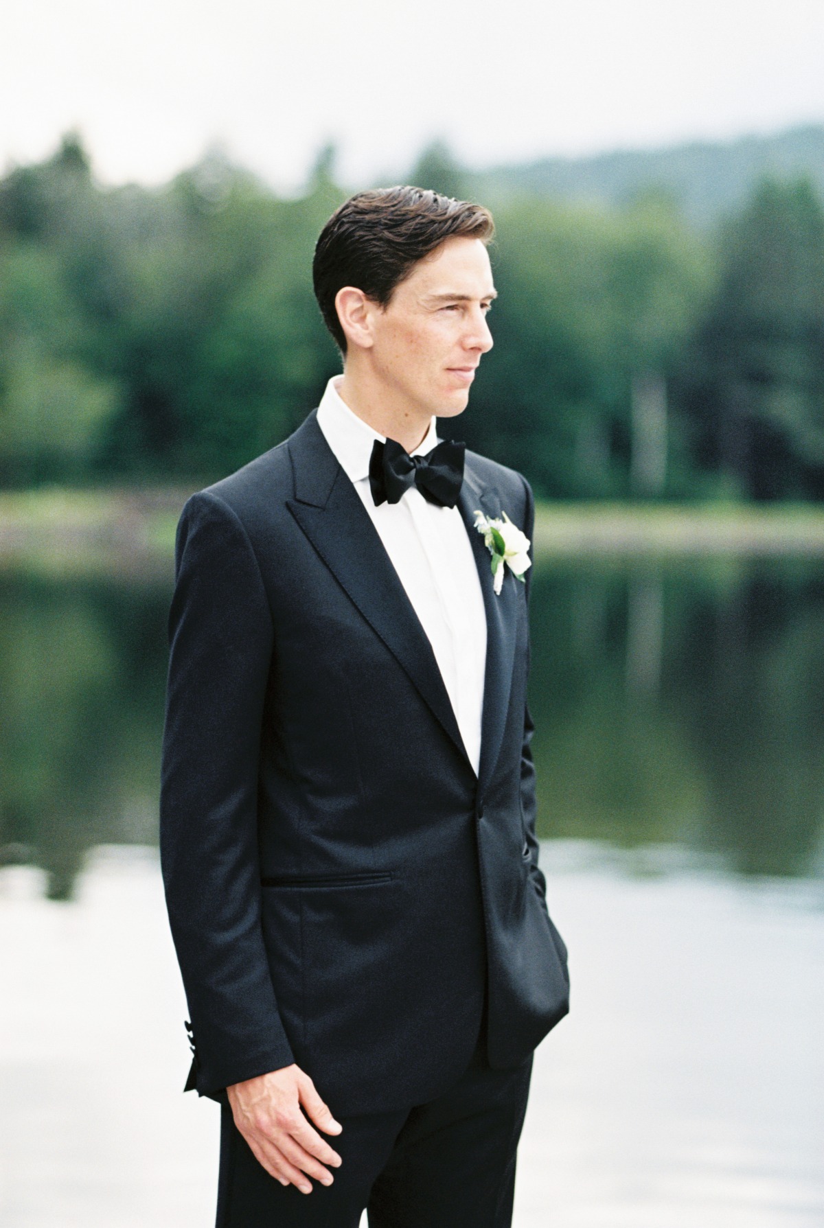 Dapper groom in traditional tuxedo for lakeside wedding 