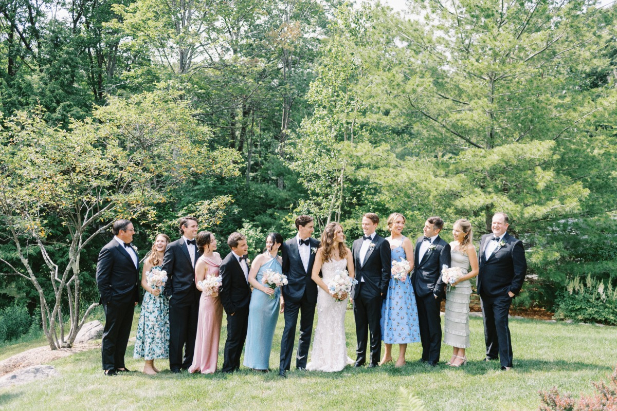Floral pastel bridesmaids with timeless groomsmen in tuxedos