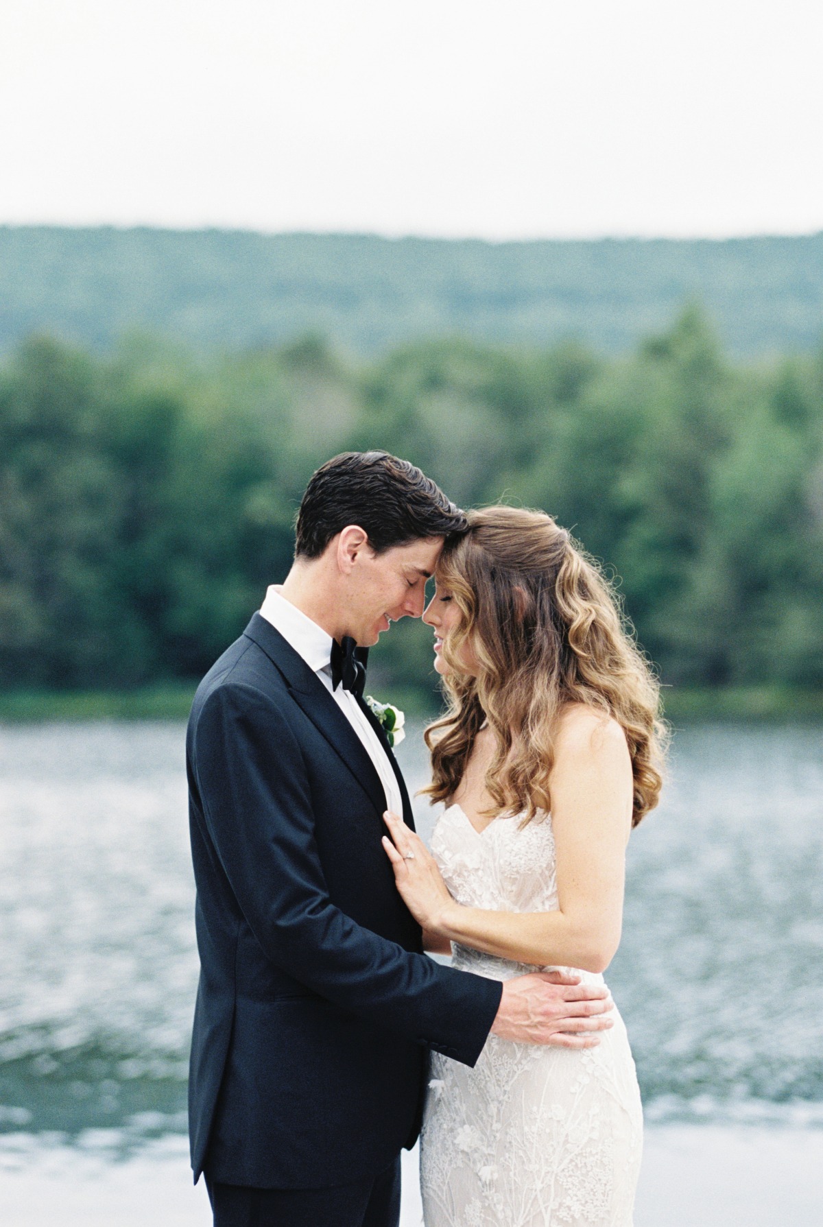 Romantic bride and groom portraits at lake in Catskills
